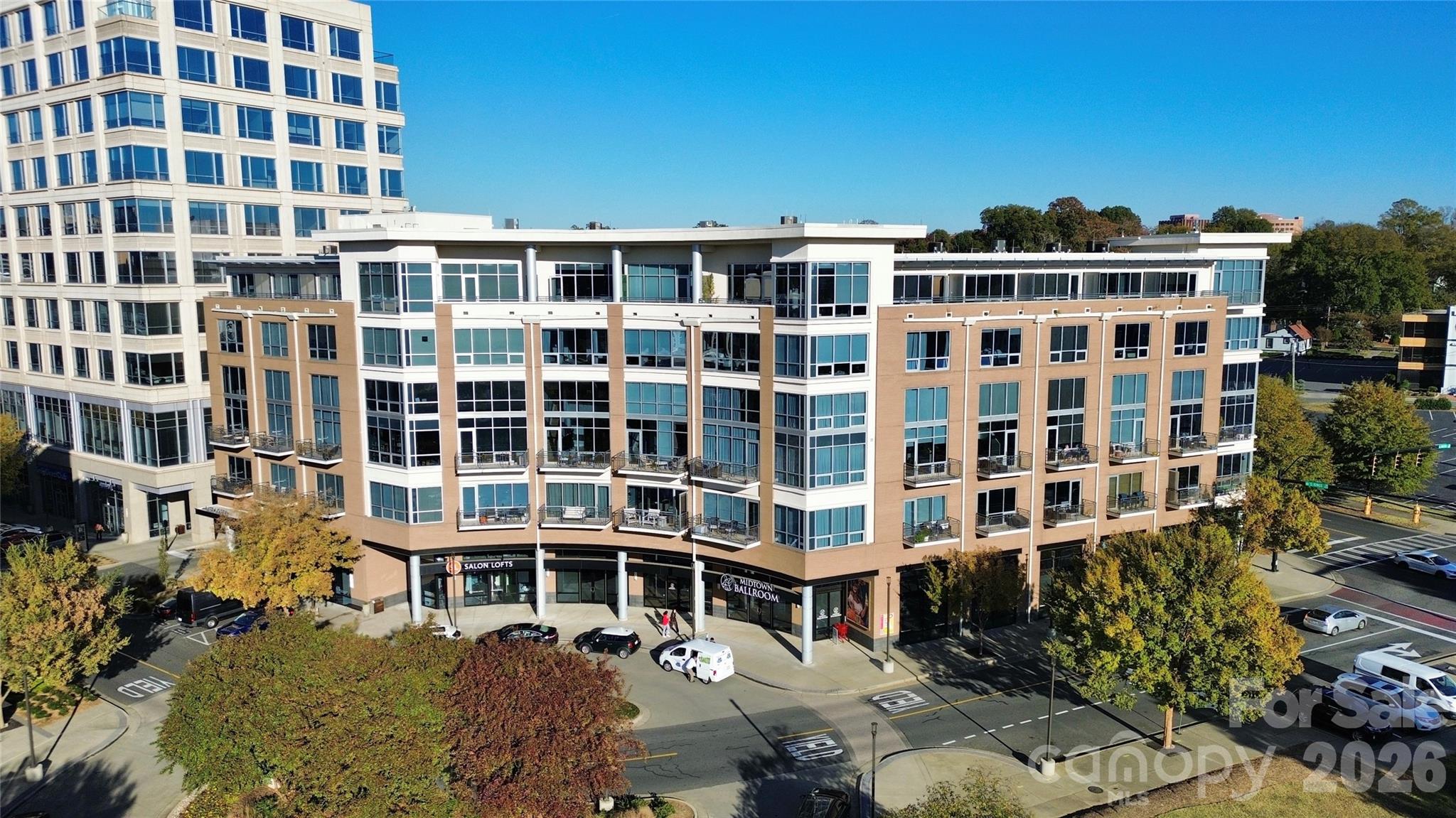 Midtown Living at its best with a view of Uptown Charlotte. This 2 story condo in MetLofts offers you the experience of location, convenience of community shopping and restaurants as well as the nearby Sugar Creek Greenway. Interior high ceilings, floor to ceiling windows, and wood flooring; Kitchen host SS appliances, Pedini Cabintry, and Breakfast bar.  Enjoy those city views from the Living/Dining area as well Primary Bedroom.  This 1300 SqFt condo provides two primary bedrooms with large walk-in custom closets. Enjoy the access to great restaurants as well as retail attached and next to this secured building: Trader Joes, Best Buy, Burlington, Target... Amenties include: Rooftop Pool, Outdoor Kitchen, Fitness Center, Clubhouse, a deeded/assigned parking space on 4th level of garage and Tesla Charging stations on 6th level of garage.