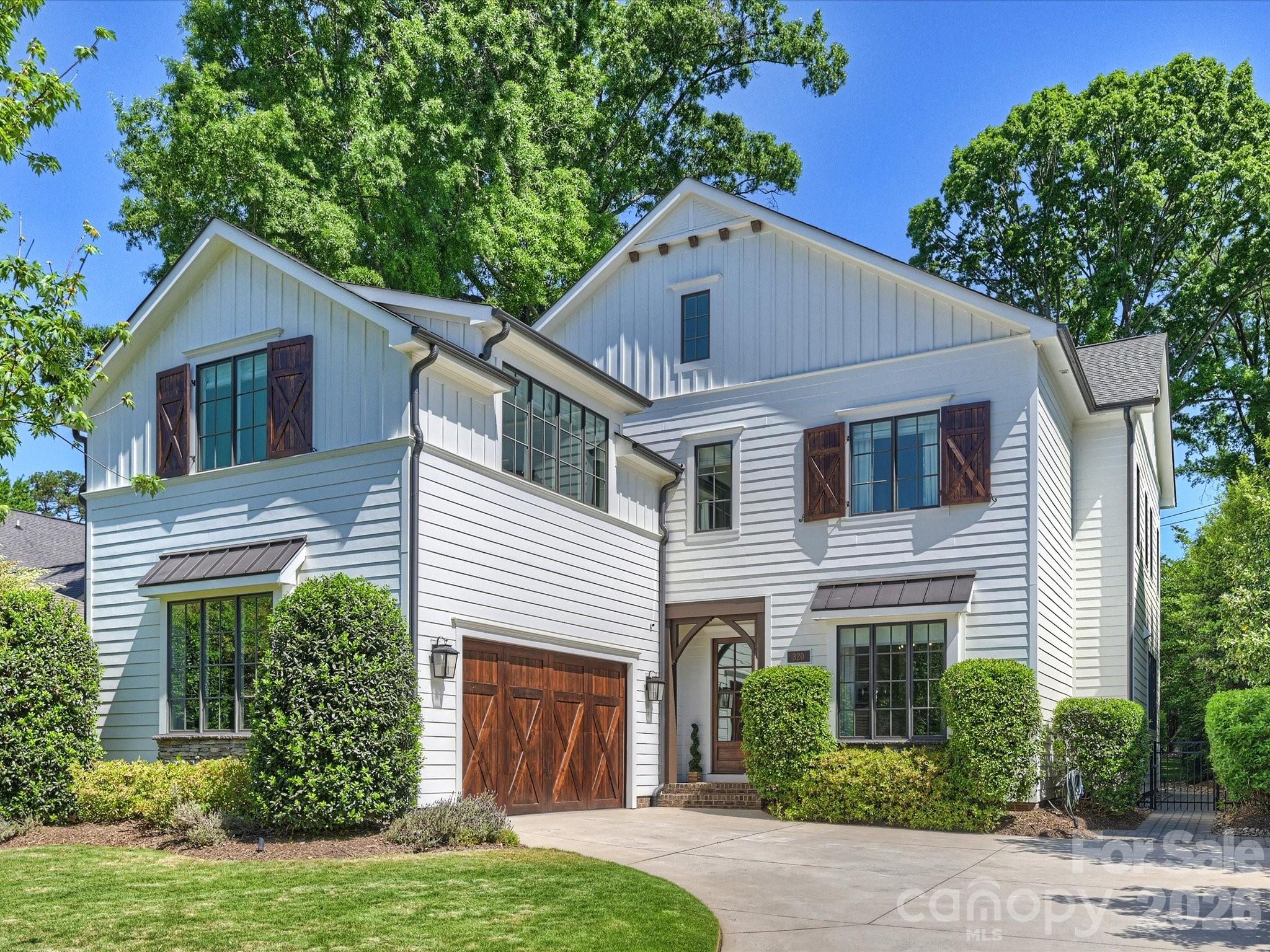 Welcome to 320 Plantation Place, the home you have been waiting for! Built in 2017 by McCormick Custom Construction, this home features numerous custom builder upgrades. Interior finishes include designer lighting throughout, custom cabinetry, walk-in pantry, SS Wolf/Subzero appliances, 10 ft ceilings on 1st floor, 9 ft on 2nd. Dining room space currently being used as an office but could be converted back to DR. Oversized great room has built-in speakers for surround sound, gas fireplace and French doors that exit to porch/patio. Entire home Generac generator was added in 2023. Custom window treatments throughout include wood woven shades and Hunter Douglas roller shades. Shades in kitchen, office, breakfast area and stairwell are motorized. Interior paint was updated in 2026. Primary bedroom features two walk-in closets, custom vanities, built-in speaker surround sound and Victoria & Albert soaking tub. 5th bedroom is currently being used as a bonus/flex space but could be converted to bedroom. Attached two-car garage has custom storage shelving installed. Exterior features include Zoysia grass in front yard and turf in rear yard. Exterior siding and trim was freshly painted in 2026. Additional features include a covered rear porch with gas burning fireplace and built-in speaker surround sound, patio with built-in grill, beverage fridge and pull-out trash. Rear yard has custom wood fence with aluminum gate. Crawl space is fully encapsulated. A short distance to Park Road Shopping Center, Sugar Creek Greenway, Selwyn Ave and South Park. You do not want to miss this one!
