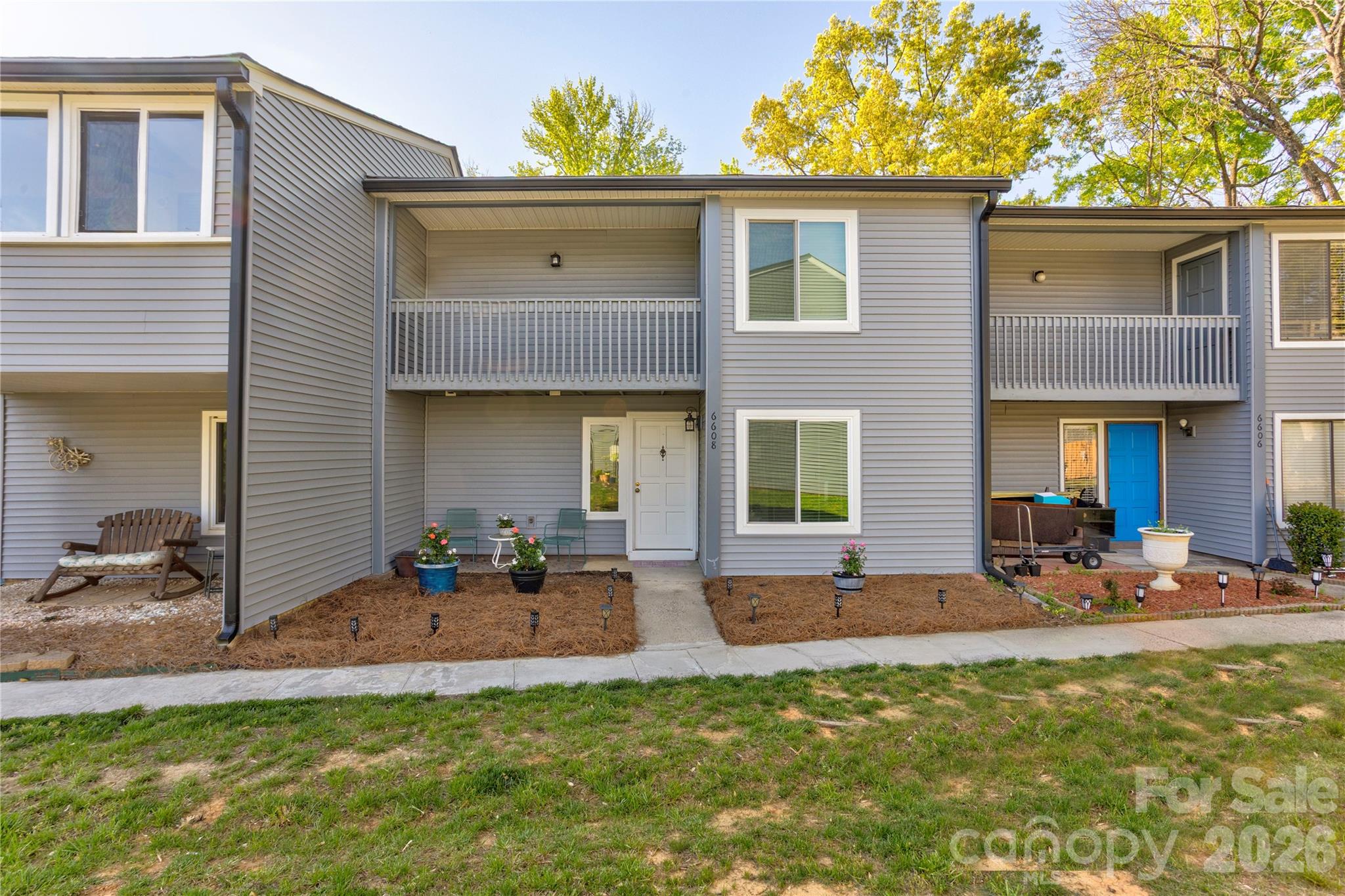This 3 bedroom, 2.5 bath condo offers a peacefulness and ease of living with close accessibility to all your daily conveniences in a premier part of South Charlotte.  Enjoy four incredible outdoor spaces - 2 terraces, a covered porch, and a large, wood deck - areas that all are ideal for the gardener, coffee drinker, or al fresco diner.  Two of them have a serene view of the tall green trees that grace the backyard.  Inside find a completely move-in ready, well maintained living space that has been tastefully updated throughout with neutral, light paint, wood laminate flooring and tile (no carpet except on the stairs), and newer windows and light weight sliding doors with lifetime warranty for energy efficiency. The beautifully upgraded kitchen has all new stainless steel appliances (2025), a subway tile backsplash, and a pantry closet.  The soaring ceilings in the ample great room create an even more spacious feel and the room flows into the dining room which has those great views of the quiet, treed backyard. On the main level, there's also a single bedroom which could double as an office, workout room or flex space, and a half bath.  The large primary bedroom on the second level has its own terrace, a large walk-in closet, and an updated en suite bathroom with dual sinks.  An additional bedroom with terrace and walk-in closet and an updated hall bathroom complete the upstairs.  Other features to note include the updated electrical panel, glass shower doors and the abundance of storage with a hall closet, an ‘under the stairs' closet, upstairs linen closet and an outdoor closet as well. Seller is offering a one year Home Warranty!! Don't miss your chance to see this home.