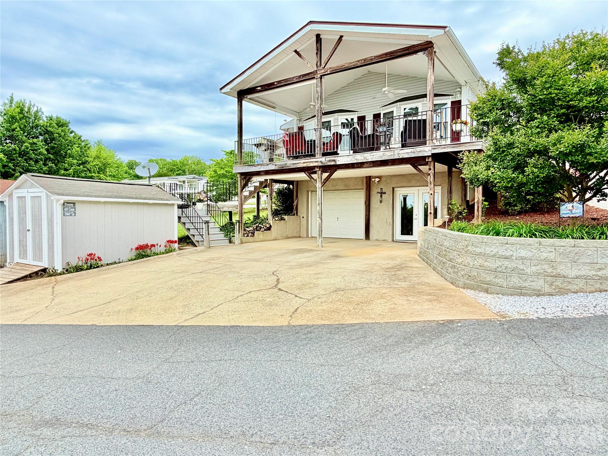 Enjoy wonderful long-range water views of Badin Lake from your spacious covered porch. This 3-bedroom, 2-bath home is located inside the gated waterfront community of Badin Shores Resort and is ideal for full-time living or the perfect lake escape. The main level features an open-concept living and kitchen area along with two bedrooms and one full bath. The updated kitchen offers custom cabinetry with soft-close drawers and pull-out shelving, granite countertops, tile backsplash, and a charming farmhouse-style sink. The main-level bath has also been updated with custom cabinetry and quartz countertops. The lower level features an additional bedroom and full bath, along with a versatile flex room ideal for a home office, hobby space, TV room, or additional sleeping area. You’ll also find a large custom-designed closet appointed with built-in shelving and drawers. A rare find within the community, this property also offers a garage—perfect for a golf cart, side-by-side, or workshop.