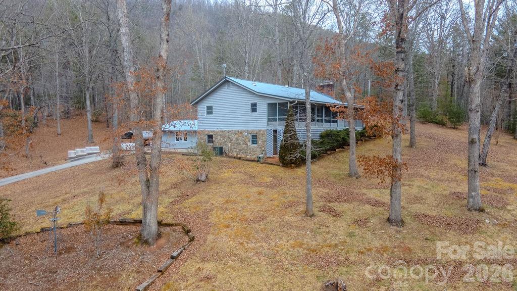 If space to work, store, and create is at the top of your list, this property delivers. Featuring a heated workshop with electricity (approx. 25x30), oversized garage, and double carport, this move-in-ready home sits on 1.7 acres of gentle, usable land and super easy access just outside Franklin, making it ideal for country living. Inside, you’ll find hardwood floors, skylights, and a comfortable, well-maintained layout. The living area features a gas fireplace that can easily be converted back to a true wood-burning fireplace. The finished basement adds valuable space with an additional family / crafts / game room and a full bath—perfect for hobbies, entertaining, or additional living space. Outdoor living shines with a covered, screened-in front porch overlooking beautiful mountain views, a wraparound deck, and a landscaped yard with mature shade trees. The surrounding wooded setting provides privacy and frequent wildlife sightings. Additional highlights include a whole-home generator, excellent cell service (Verizon), and a solid, well-built home. Peaceful and private—this property offers space, freedom, and functionality rarely found together.