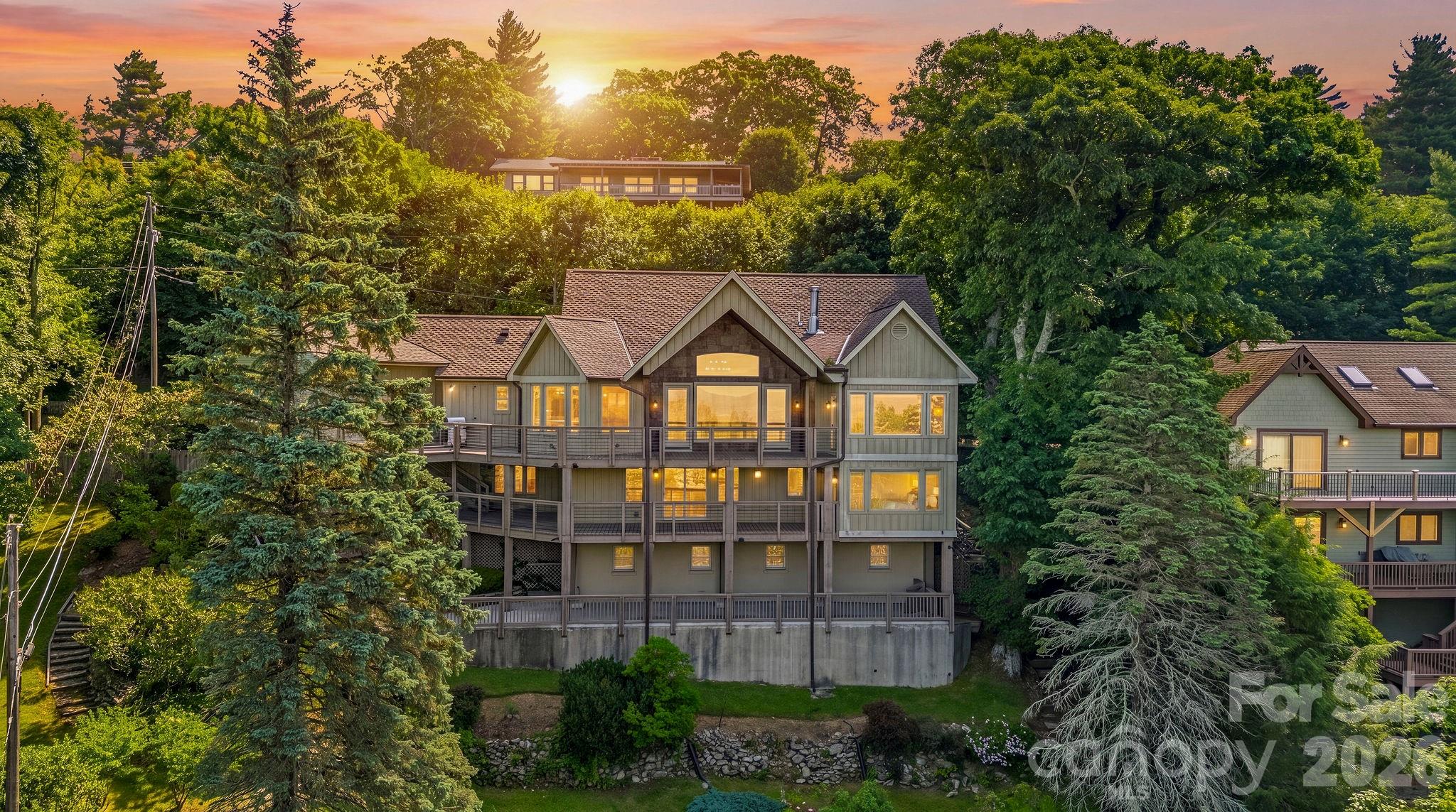 Experience elegant mountain living in this warm and inviting retreat ,perfectly situated on a large double lot with breathtaking long-range views just minutes from downtown Blowing Rock . From the moment you step into the welcoming foyer, you'll be captivated by the phenomenal mountain view that set the tone for this exceptional home. The open concept floorplan is designed to showcase the scenery from nearly every room while offering the perfect blend of comfort and sophistication. The chef's kitchen is beautifully appointed with granite countertops, a Wolfe gas range, Sub-Zero refrigerator, custom cabinetry, and a sunny breakfast room-ideal place to enjoy your morning coffee while taking in the view! The great room features vaulted ceiling, a stack stone fireplace, beautiful hardwood floors , and dramatic windows that fill the house with natural light and frame the mountain view. The mail-level primary suite is a peaceful sanctuary offering gorgeous views and a luxurious bath with marble flooring. Down stairs, you'll find a second primary suite with great built ins and nice bath. A super wet bar, Two additional bedrooms , 2 and 1/2 baths, provide plenty of space for all. A spacious family room with a fireplace creates the perfect setting for relaxing and entertaining. The Third level offers incredible flexibility with an additional bedroom, full bath and closet, making it convenient for a guest suite, recreation room, office, or creative space. Outdoor living is just as impressive , featuring two expansive wrap around porches and a large patio on lower level where you can relax, entertain, and enjoy the beauty of the Blue Ridge Mountains. A two car garage, double lot with plenty of flat land play area , or for gardening, and walk out all levels providing exceptional convenience and accessibility! This is a well built lovely home furnished very tastefully and comfortably for you to add your personal touches ! Close proximity to Blowing Rock Country Club!