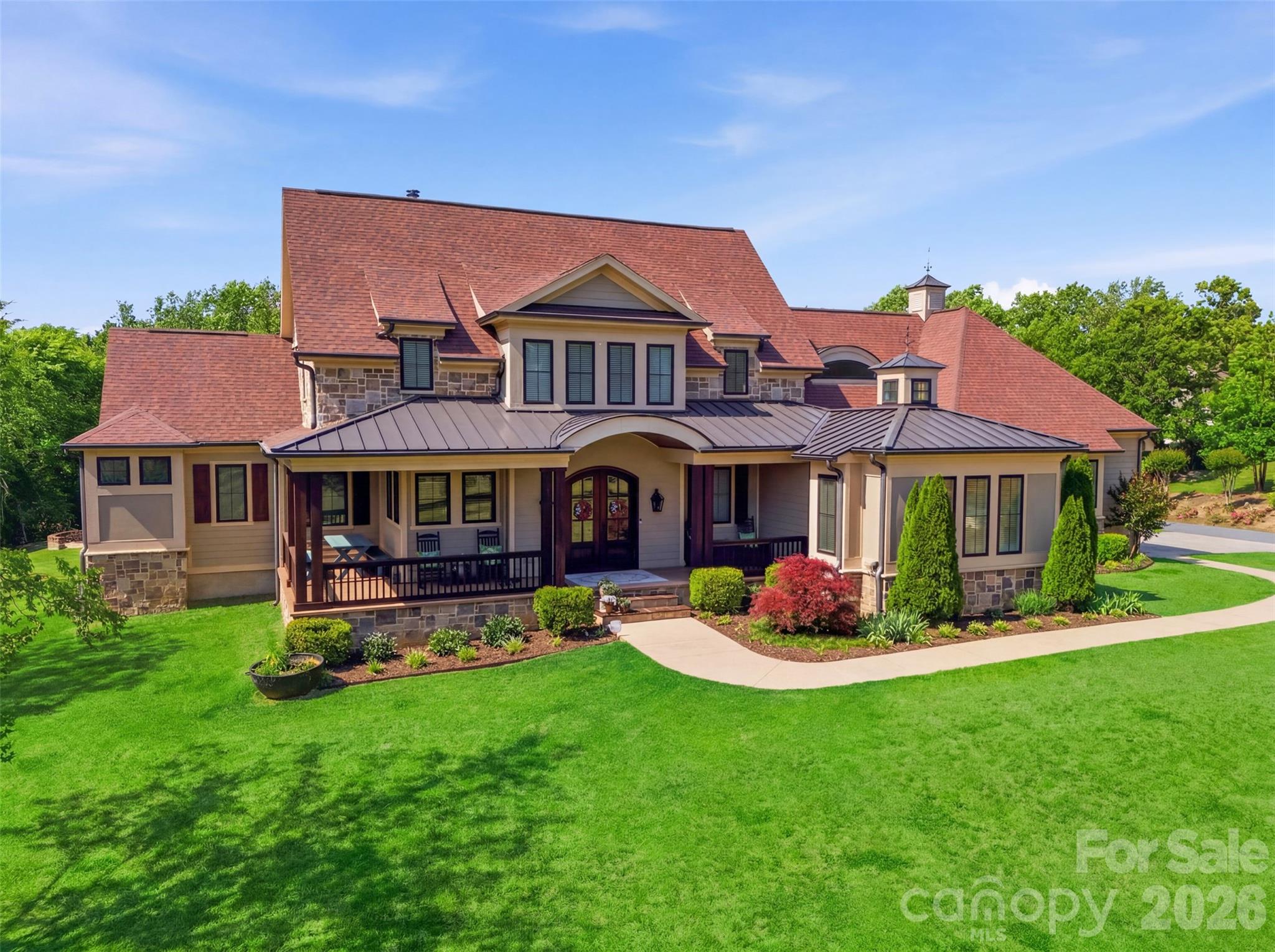 Gracefully situated on 2.69 private acres in a highly sought-after Davidson Equestrian community, this custom-designed two-story modern rustic estate by J.J. Barja offers an exceptional blend of luxury, warmth, and privacy. Designed for both everyday living and effortless entertaining, the home features an open-concept floor plan with a main-level primary suite and an optional second primary suite on the main floor. The chef’s kitchen is a true centerpiece, showcasing a Lacanche Range and two oversized islands ideal for gathering and entertaining. Rich Douglas Fir hardwood floors run throughout the home, adding timeless character and warmth. A spacious bonus retreat features eight custom built-in bunks, creating the ultimate sleepover or guest space. Expansive covered and screened porches seamlessly extend the living areas outdoors, overlooking a salt water pool and serene wooded backdrop for privacy and tranquility.