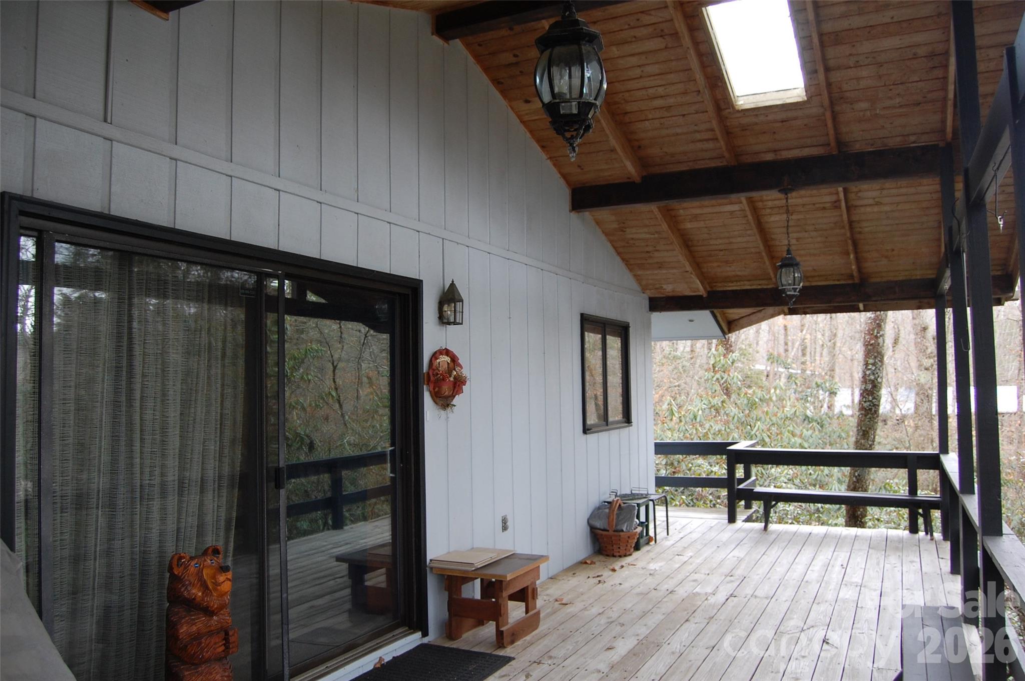 Treehouse set in the Rhododendron at Linville Land Harbor. Bring your plans to update this 80s home and make it your very own mountain retreat. Fabulous covered porch for enjoying your elevation! Parking area on Knoll Circle with steps down to the house. This generous lot in a homes only section of Land Harbor (NO RVs or Park Models) will allow for some expansion. Community has golf, pickleball, tennis, fishing, seasonal outdoor heated swimming pool and so much more. Summer finds Friday nights gathered at The Landing for live music. The Patio Grill is open from May to September offering a quick bit of lunch after enjoying a day at the pool or on the golf course. So much to do in this mountain resort community that you'll want to call it home year-round!