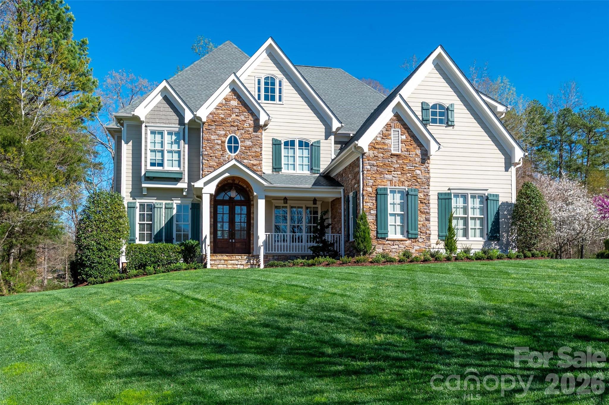 Stunning custom estate in the highly sought-after Springfield community. Perfectly positioned on a coveted cul-de-sac and set on one of Springfield’s largest homesites (.74 acres). From the moment you arrive, the home’s striking curb appeal and timeless Southern elegance make a lasting impression. Double wood entry doors, expansive flagstone front and rear porches, and an oversized 3-car garage welcome you home. Sun-filled interiors create a bright, inviting atmosphere throughout.

Main Level: Grand two-story foyer; rich natural-tone flooring; executive office; impressive great room; bonus room and butler’s pantry with custom built-ins; extensive architectural moldings; private first-floor guest ensuite; and a highly desirable open-concept layout ideal for both everyday living and entertaining.

Upper Level: Luxurious primary retreat featuring a sitting area, fireplace, and two spacious walk-in closets; three additional bedrooms plus a versatile bonus room.

Third Floor: Private bedroom or flex space with full bath and an additional oversized bonus room—perfect for a media room, fitness space, or retreat.

Springfield amenities include membership to Anne Springs Close Greenway, resort-style pool, tennis and pickleball courts, playground, clubhouse, pocket parks, and fitness center. An 18-hole public golf course is also located within the community.