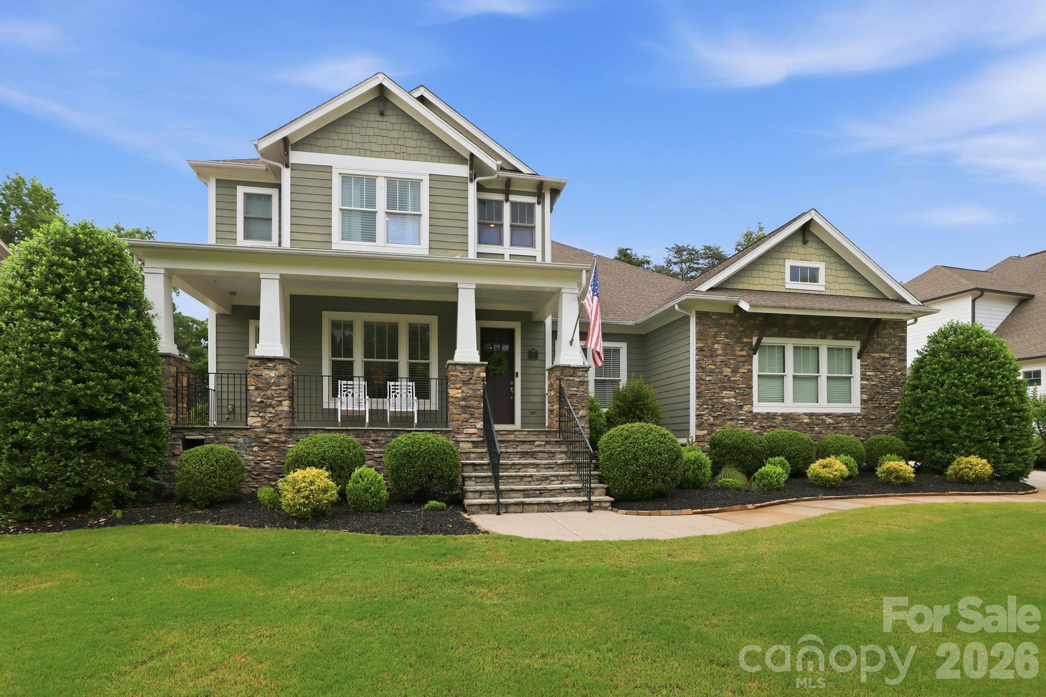 Impressive 5 Bedroom Home on Springfield Golf Course in a Premier Fort Mill Neighborhood. Just minutes from downtown Fort Mill and an easy commute to Uptown Charlotte and Charlotte Douglass Airport. This beautifully maintained 5 bedroom, 4.5 bathroom home is move-in ready and designed for both everyday living and exceptional entertaining. The welcoming front porch greets you into a gracious foyer, flanked by a formal dining room and in home office that both overlook the front yard. The heart of the home features an open concept kitchen and living area, thoughtfully designed for gathering. Step outside the main living area to your oversized covered back porch with fireplace, private flat usable yard, and stamped concrete patio where the hot tub awaits. Back inside the Primary suite is tucked away on the main level for ultimate privacy. The Primary Bath has been fully remodeled and is a spa-like oasis. An additional bedroom on the primary level with an ensuite bath awaits your guests. Head upstairs on the beautiful curved staircase, where you will find three bedrooms, two full bathrooms and a bonus room perfect to function as a media room, guest retreat or playroom. This is truly an entertainer's and family dream, offering exceptional space, comfort, and prime location. A gem not to be missed. The neighborhood offers an assortment of amenities including clubhouse, pools, playgrounds, tennis courts (finishing up complete replacement of six tennis courts and pickleball courts), walking trails, and a public golf course that is a separate pay-to-play course. HOA dues also include an annual family membership to Anne Springs Greenway, which is located across from the neighborhood. Price includes buyer credit for exterior painting (choose the same color or buyer has ability to change exterior color based on ARC approval).