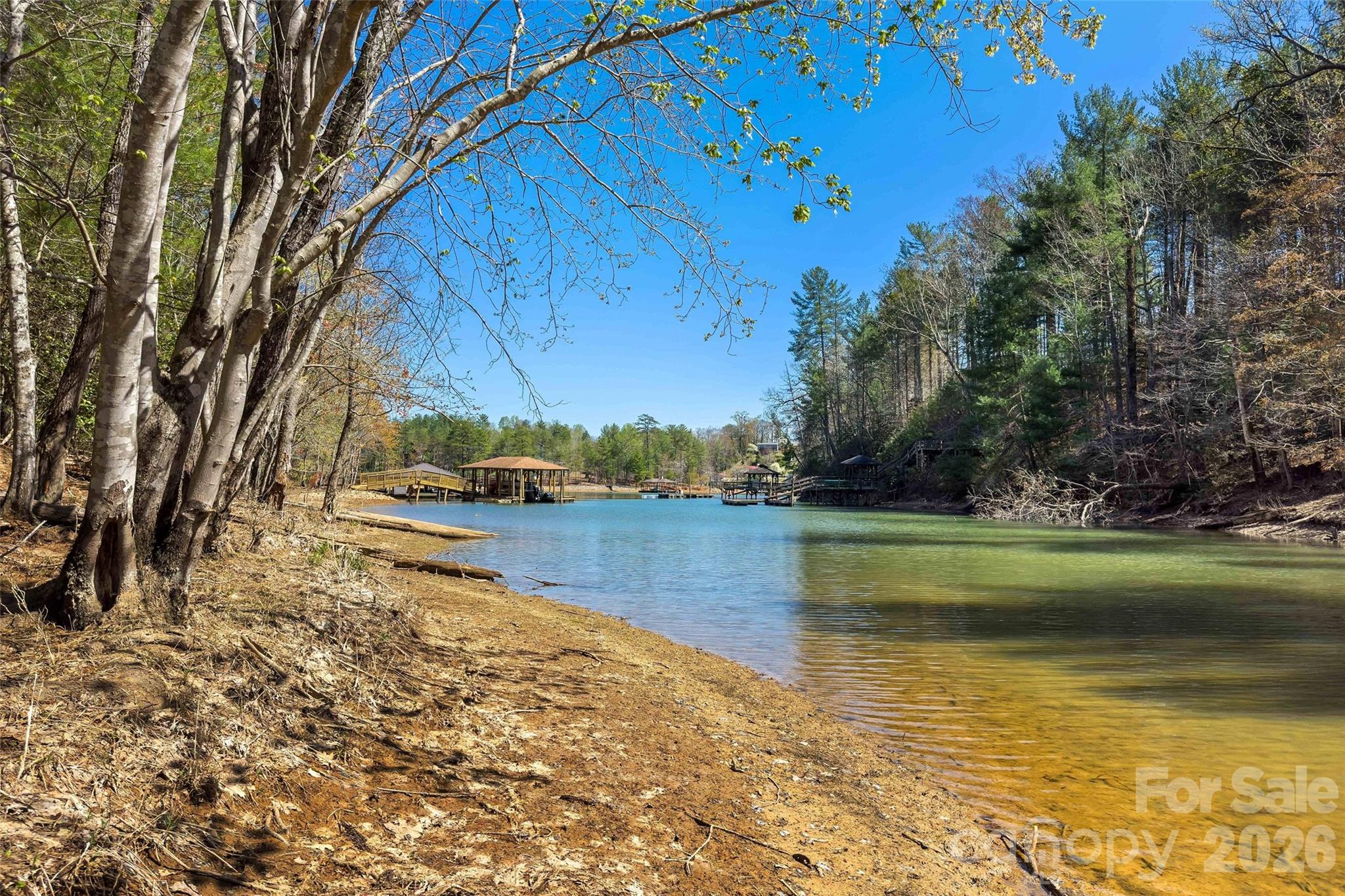 Build your waterfront dream home at Lake James, in the pristine gated community of Waters Edge. The property features a great build site and 168 feet of shoreline with a very gentle slope down to the water. This partially cleared, 0.94-acre waterfront lot has it's own beach, providing easy access to a quiet cove. Waters Edge is a gated community offering amenities such as a private swimming beach, a communal fire pit area, and access to the Fonta Flora mountain biking and hiking trail, which encircles the eastern side of Lake James. Short term rentals are allowed!