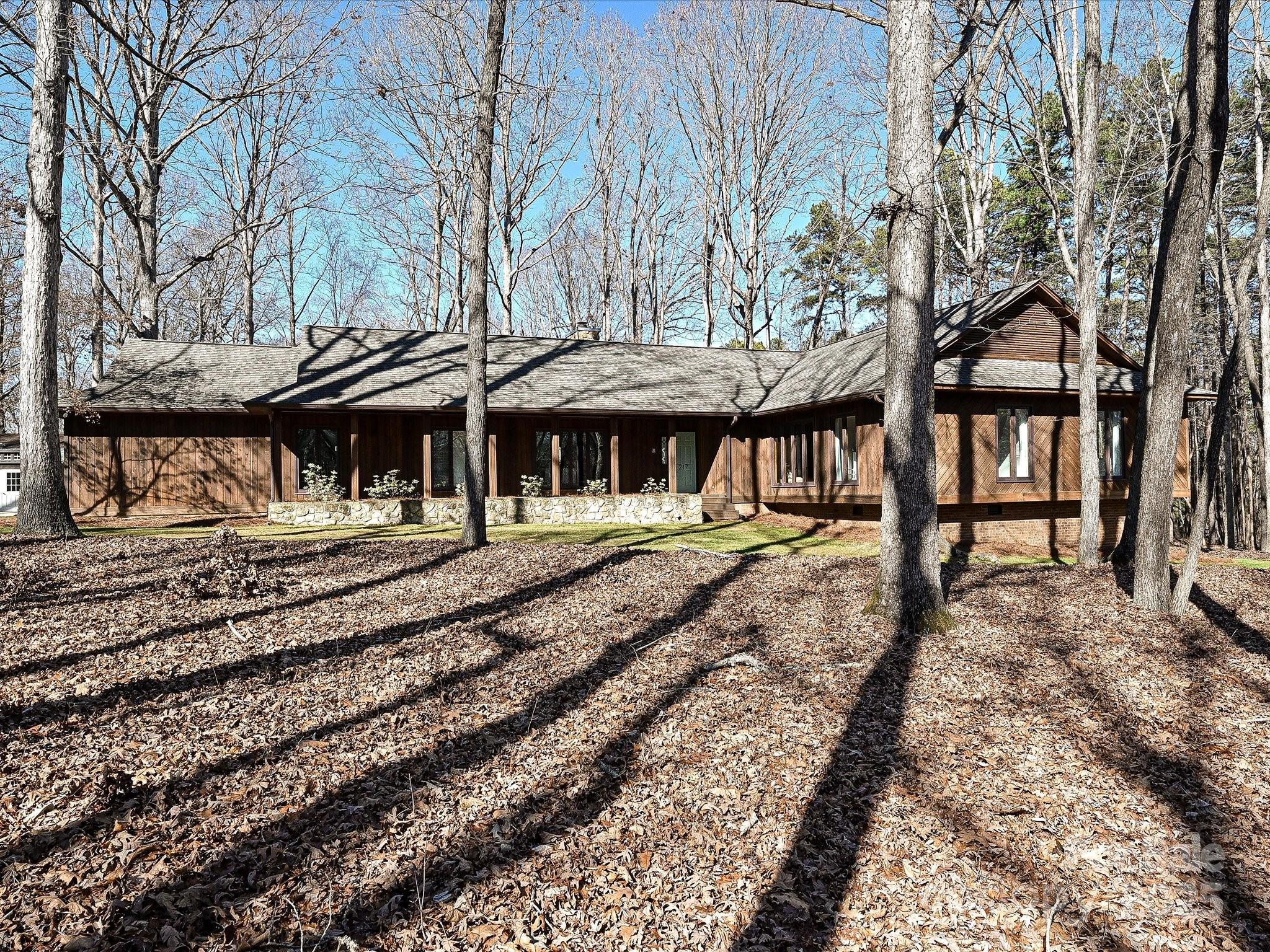 Beautiful mid century modern architectural with a rustic flair of rough sawn cedar siding. This one story home offers unique interior styling with soaring cathedral ceiling in the great room and huge stone fireplace. Entering the foyer from the covered front porch you'll find a formal dining room, open hallway leading to the bedrooms, kitchen and breakfast area open to the great room with engineered hardwood floors throughout the main living areas. The great room and breakfast area offer access to the rear deck and beautiful views of the 2.51 acre flat lot with perimeter trees and a sun filled backyard. The three secondary bedrooms are off a large bonus room creating a separate social area from the great room. The nicely sized primary bedroom has a great WIC and standup shower feature. From the two car side load garage is the fully conditioned flex area plus huge standup and floored storage area above the garage and main floor. Standup crawl with concrete pad plus 11X16 workshop shed.
