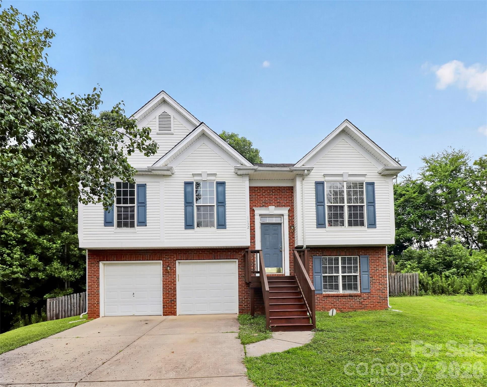 This updated home has plenty of space to spread out, both inside and out! The main level features the living room, kitchen, dining area, primary bedroom, two additional bedrooms, and a full bath. Downstairs you'll find a large second living/family room, a fourth bedroom, half bath, and laundry room giving everyone a little extra room to enjoy. Step outside to the upper-level deck, the perfect spot to relax or grill out. The covered patio below offers even more outdoor living space. The large, fully fenced backyard is great for kids, pets, or simply enjoying time outside. The location is hard to beat, just minutes from all the shopping, dining, and entertainment the University area has to offer plus quick access to both I-485 and I-85, making it easy to get wherever you need to go around Charlotte.