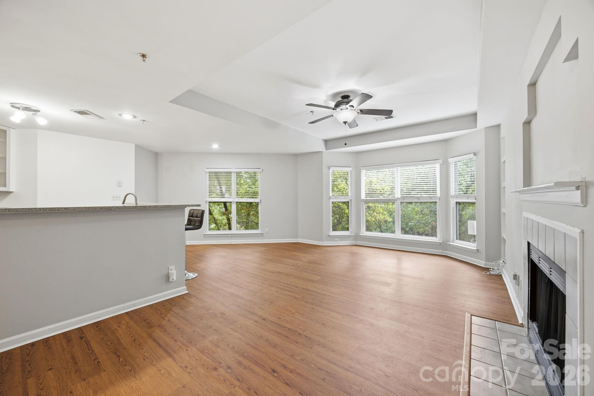 MOTIVATED SELLER. BRING AN OFFER! Includes 2 parking spaces dedicated for the unit, one of which is covered! The pool, fitness center, clubhouse, dog park, grilling area, water, sewer, and trash all included by HOA. This 2 bed, 2.5 bath, top floor condo in Fourth Ward has many recent upgrades including a new roof (2024), new washer and dryer (2024), new flooring (2025), new water heater (2025), smart thermostat, and newly installed fire sprinklers throughout the unit. Non covered parking space is #51 and covered space is #45. Located just moments from Uptown Charlotte’s dining, entertainment, parks, and business district, this condo offers the perfect combination of comfort, convenience, and low maintenance living.