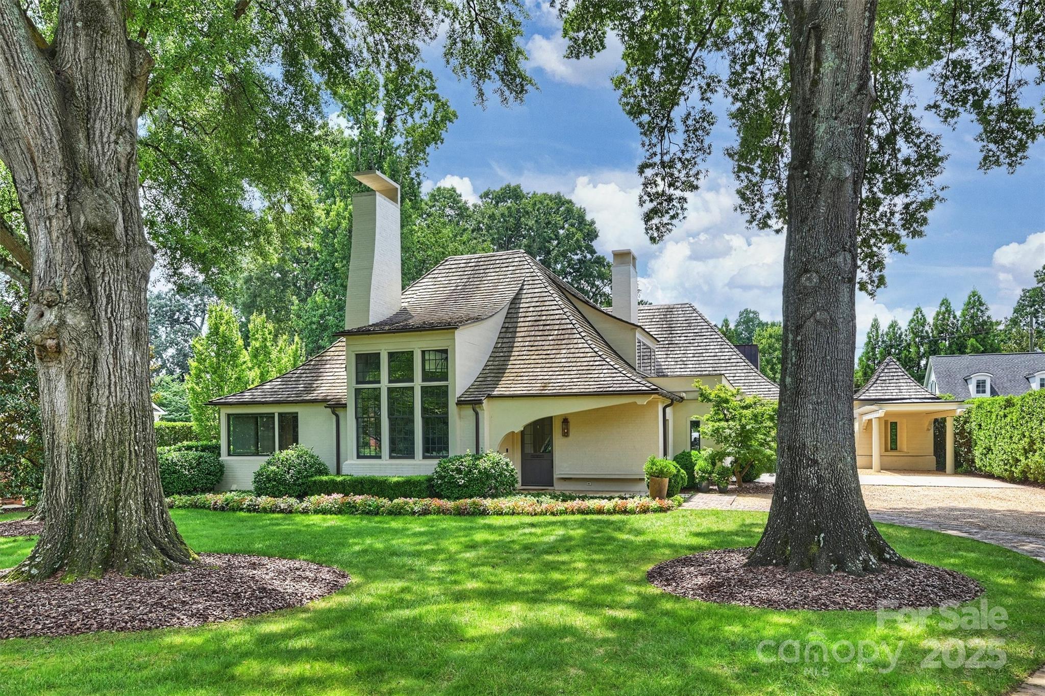 Welcome to your own private resort! One-of-a-kind custom home designed by acclaimed architect Ken Pursley and perfectly positioned in the heart of Foxcroft. Extraordinary craftsmanship and architectural detail are evident throughout sophisticated formal and relaxed living spaces—ideal for intimate gatherings or large-scale entertaining. The main level features a stunning family room with vaulted brick archways, a designer kitchen with scullery, two private offices, and a serene primary suite with spa-inspired bath. Four secondary ensuite bedrooms and a stylish lounge complete the upper level. The fully finished basement boasts an impressive bar, billiards area, media room, fitness room, and temperature-controlled wine room. Seamless indoor-outdoor living unfolds across expansive covered and open terraces with outdoor kitchen, gas firepit, and views of the resort-style saltwater pool and spa, complemented by a pool cabana with fireplace and bath. Elevator to all floors, generator, dog wash, and abundant storage. A truly unmatched luxury lifestyle in one of Charlotte’s most prestigious neighborhoods.