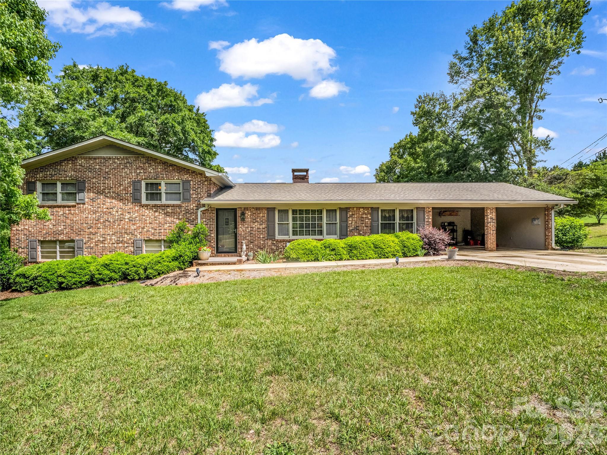 Nestled on approximately 7 picturesque acres in Polk, this classic brick ranch estate offers an exceptional blend of privacy, functionality, and refined country living. Surrounded by mature trees, open pasture, and peaceful wooded acreage, the property delivers the tranquility and seclusion discerning buyers seek while remaining conveniently located in the heart of Green Creek, Tryon area.

The main residence features 3 bedrooms and 2 full bathrooms on the upper level of a split-level home. Designed for both comfortable everyday living and effortless entertaining, the main level showcases an open kitchen, a private office, pantry, or flexible formal dining room. Inviting living areas are filled with timeless character and natural light, creating a warm and welcoming atmosphere throughout. The laundry area is conveniently located in the basement. Thoughtful recent improvements include new appliances & hot water heater- less than 7 months old, a beautifully remodeled hall bathroom, and a new roof with stainless steel gutters-completed within the last three years. An
attached two-car carport and additional concrete parking provide both convenience and functionality. The expansive acreage offers endless possibilities for an equestrian retreat, private homestead, hobby farm, or multi-generational estate. With a rare combination of usable land and natural beauty, this property creates a true retreat-like atmosphere just minutes from the charm, dining, and culture of The Tryon International Equestrian Center. 

Adding exceptional value is the separate garage apartment located at 90 McEntire Rd adjacent to the main residence. This versatile guest quarters includes a two-car garage, flex room. and bathroom on the main level, with upstairs living space featuring 1 bedroom and 1 full bathroom. Ideal for guests, extended family, a private office, caretaker accommodations, or continued rental income potential. The garage apartment is currently tenant-occupied through at least October, and the tenant has expressed interest in remaining with the new owner, offering an immediate income-producing opportunity from day one. 

The estate is comprised of three separately deeded parcels offering flexibility and future potential: 2.41 acres with the main residence, 1.77 acres with the garage apartment, and 2.93 acres of open field/pasture behind both structures. Offering acreage privacy, multiple living spaces, and investment potential in one of Western North Carolina's most sought-after small-town settings, this unique property presents a rare opportunity to enjoy elevated country living in beautiful Tryon.