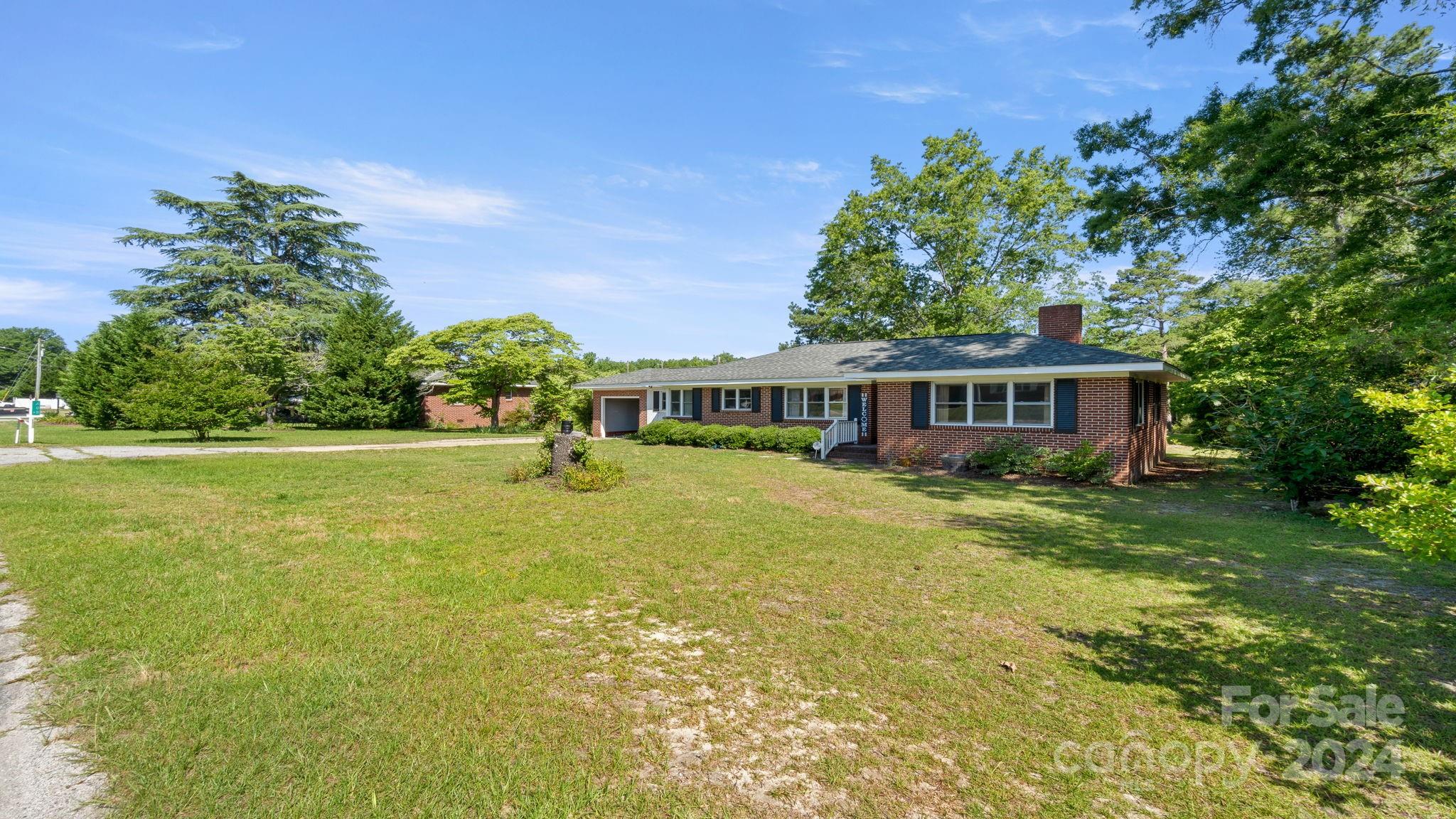 Come see this terrific brick home in Kershaw!  You'll love walking into this large ranch home with so much to offer!  Large primary bedroom with dual closets, two additional roomy bedrooms, front living/family room with gas fireplace that can be closed off for privacy or used as a home office!  Additional seating area in main area of the home and a kitchen with tons of counter space for cooking and holiday dinners.  Large laundry/mudroom between the garage and home that also features a full bathroom.  Relax out back on the large deck overlooking the flat yard with plenty of space for gardening or hobbies.  Shed in the back of the property for storage as well!