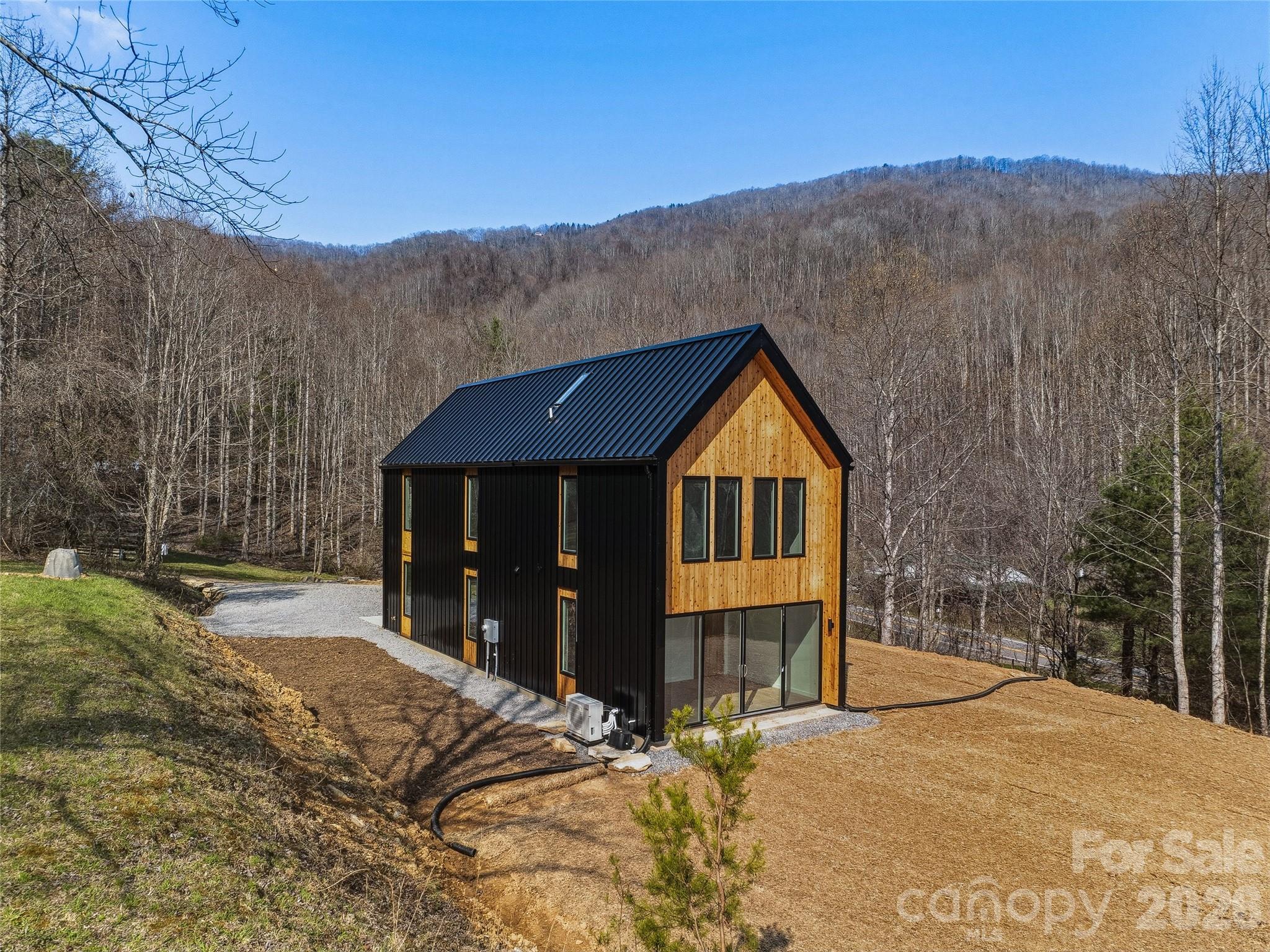 *This house comes with a REDUCED RATE as low as 5.750% (APR 6.278%) as of 5/18/2026 through List & Lock™. This is a seller paid rate-buydown that reduces the buyer's interest rate and monthly payment. Terms apply. Ask listing agent for more information and see info on MLS. Sleek modern design, tasteful finishes, and a picture-perfect setting make this new construction home a must see property! Floor-to-ceiling windows frame a stunning view of the valley from the main level primary suite. Well appointed kitchen anchored by a marble waterfall island- featuring tiled backsplash, and stainless steel appliances. Flexible loft space on upper level overlooks living space and is met by wooded hillside views. Upper level bedroom features additional views of the valley. Elegantly styled bathrooms with tiled enclosures. Bonus space in cubby above loft perfect for additional space or storage. Enjoy the peace and privacy in the rural backdrop of Leicester. Whisper Mountain is a private gated mountain community with 50 homesites spread over 450 acres. Featuring a clubhouse, walking trails, and protected green spaces. Fiber internet is available in the community. No restrictions on short term rentals. Community entrance located on Highway 63- future expansion and development along this corridor will continue to bring amenities closer to the rural communities. 35 minutes to downtown Asheville.