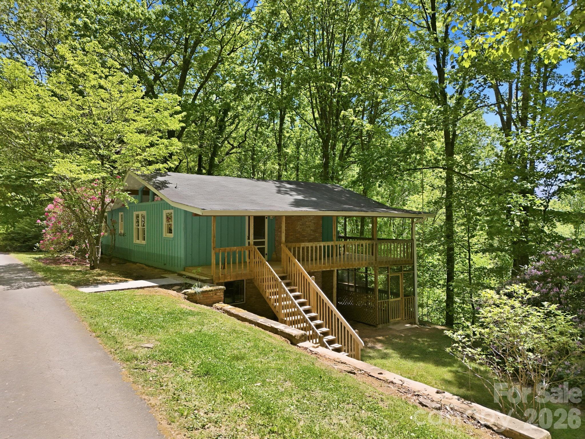 If you've been searching for the perfect mountain getaway, look no further than Dream Mountain.

Nestled in the picturesque mountains of Cruso, North Carolina, this beautifully maintained home offers stunning year-round long-range views and the ideal combination of comfort, privacy, and mountain charm.

Designed to embrace the natural beauty that surrounds it, the home features a spacious wraparound upper deck, perfect for entertaining or simply enjoying the breathtaking scenery. On the lower level, you'll find an expansive screened porch located just off the family room, providing a private outdoor retreat with ample space for relaxing or even adding a hot tub.

Originally built in 1984, this home has been meticulously cared for and is truly move-in ready. Offered fully furnished, it allows the next owner to begin enjoying mountain living from day one. Additional amenities include a basement garage and a dedicated workshop area, offering valuable storage and workspace.

Adding even more value, the sale includes a second adjoining tract of approximately 0.91 acres, bringing the total property size to approximately 1.57 acres of beautiful mountain land.

Situated within a gated community, the property enjoys enhanced privacy and security without the expense of HOA dues. A modest annual road maintenance agreement helps ensure convenient year-round access.

Please note: The septic permit on record reflects a two-bedroom home. Buyers and/or their agent should verify all septic information and suitability for their intended use.

Whether you're looking for a full-time residence, a vacation home, or a peaceful mountain retreat, Dream Mountain offers a rare opportunity to own a slice of Western North Carolina paradise with spectacular views and exceptional tranquility.