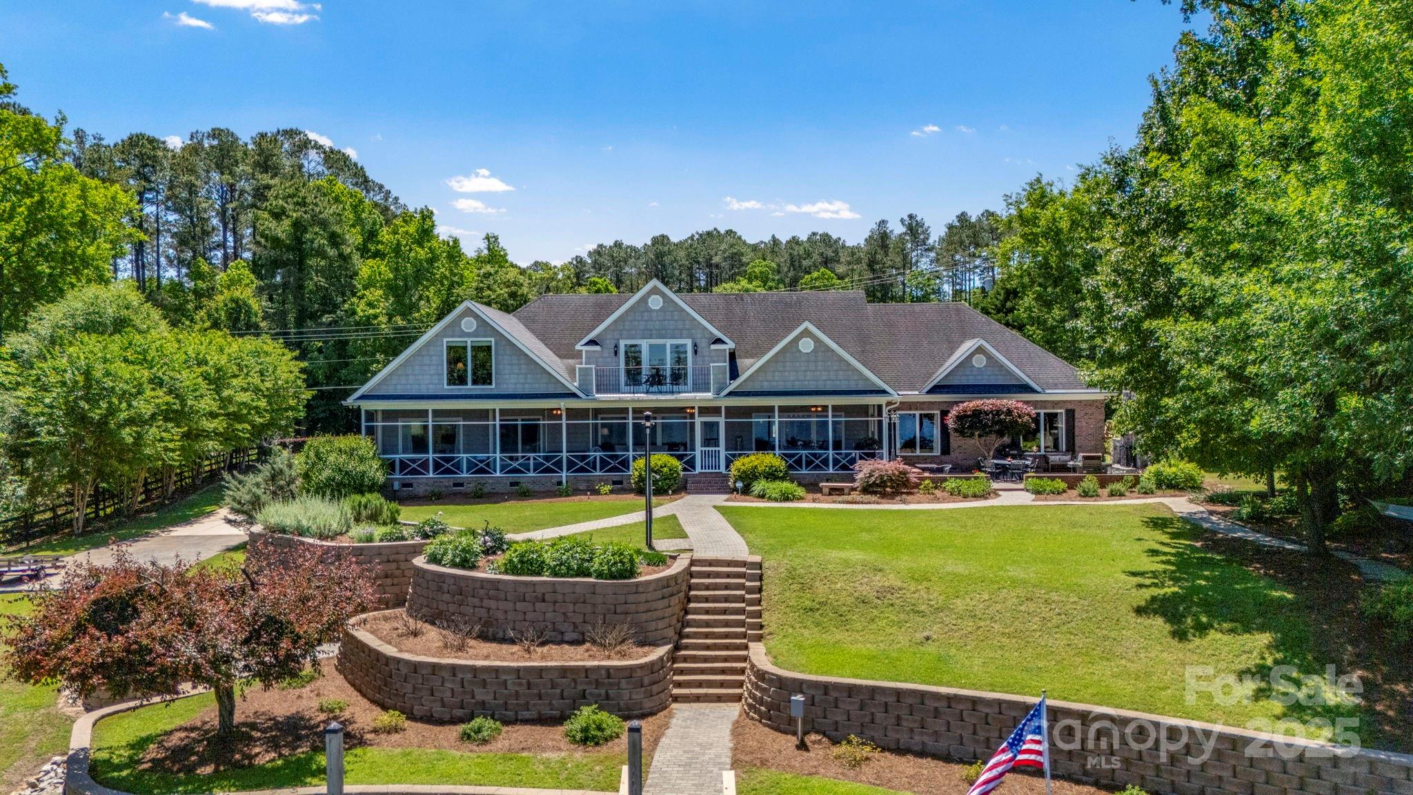 Experience lake life at its absolute best! Move in ready! Well-appointed, home features a main channel view, 268 ft on the water & a composite dock w/ 2 remote control boat lifts. Designed for easy main level living. Open floor plan, 9 ft ceilings, HW floors, neutral colors and generously sized rooms. Main level Owner retreat boasts spacious BR, Bath w/ quartzite ctops, dual sinks, dual walk-in closets, tile floors/shower plus a Flex Room to suit any need. Dream Kitchen features stunning Taj Mahal quartzite ctops, huge island, GE SS Monogram/Cafe appliances. Large Guest ensuite on Main. Unmatched outdoor living spaces! Dine lakeside on screened porch, cozy up by the outdoor FP or soak in the hot tub. Unbelievable Lower Garage/Workshop for tools, toys & more. Additional features: Rinnai tankless WH, walk-in attic w/ foam insulation, Anderson windows/doors, full irrigation from lake, great views! Only 20 min to Camden/Lugoff restaurants & shopping! Easy commute to Charlotte & Columbia.