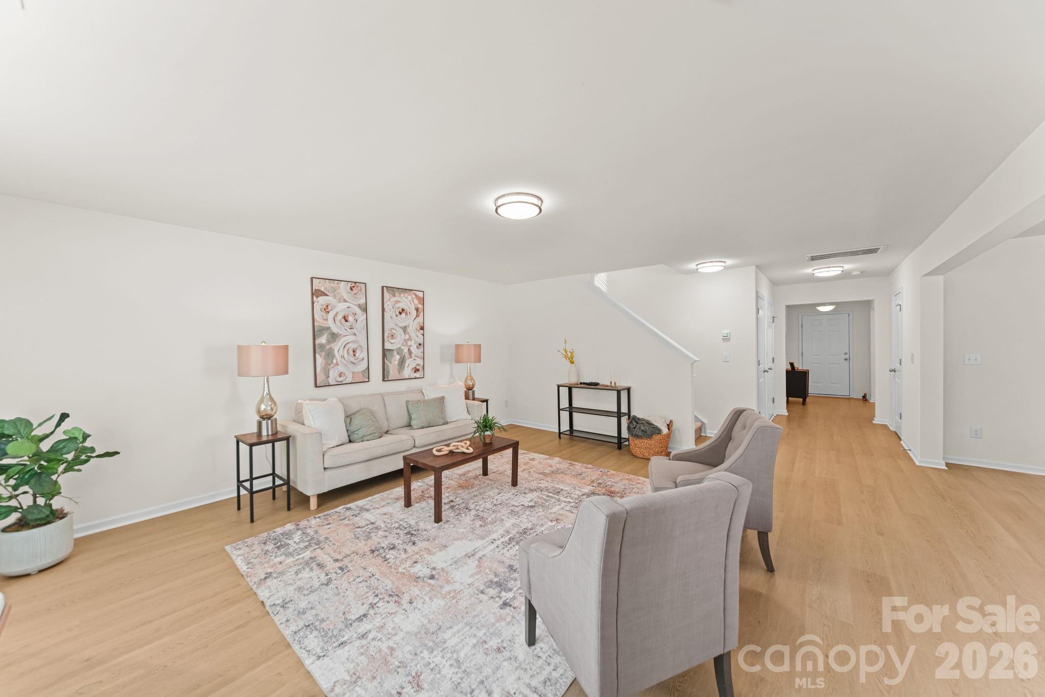 Come and tour this low-maintenance, beautifully designed home with nearly 2,000 square feet of comfortable living space. This home still feels like new and features a functional modern layout with generous living areas, 3 spacious bedrooms PLUS a loft, and the convenience of a half bath on the main level. Fresh paint and new flooring create a clean, move-in-ready canvas for your personal style. The open-concept design provides an easy flow for everyday living, entertaining, and relaxing at home. The kitchen, dining, and living areas offer plenty of room to gather, while the upstairs bedrooms and loft provide privacy and flexibility for family, guests, a home office, hobby space, or additional living area.Additional features include a 1-car garage and a flat backyard, offering practical space both inside and out. Located in York, this property offers the appeal of a quieter setting while still providing convenient access to charming downtown York, local schools, everyday conveniences, and the recreation and waterfront activities of nearby Lake Wylie. Whether you are a first-time buyer, move-up buyer, or investor, this is a great opportunity to own a newer, like-new home in a growing York County market.