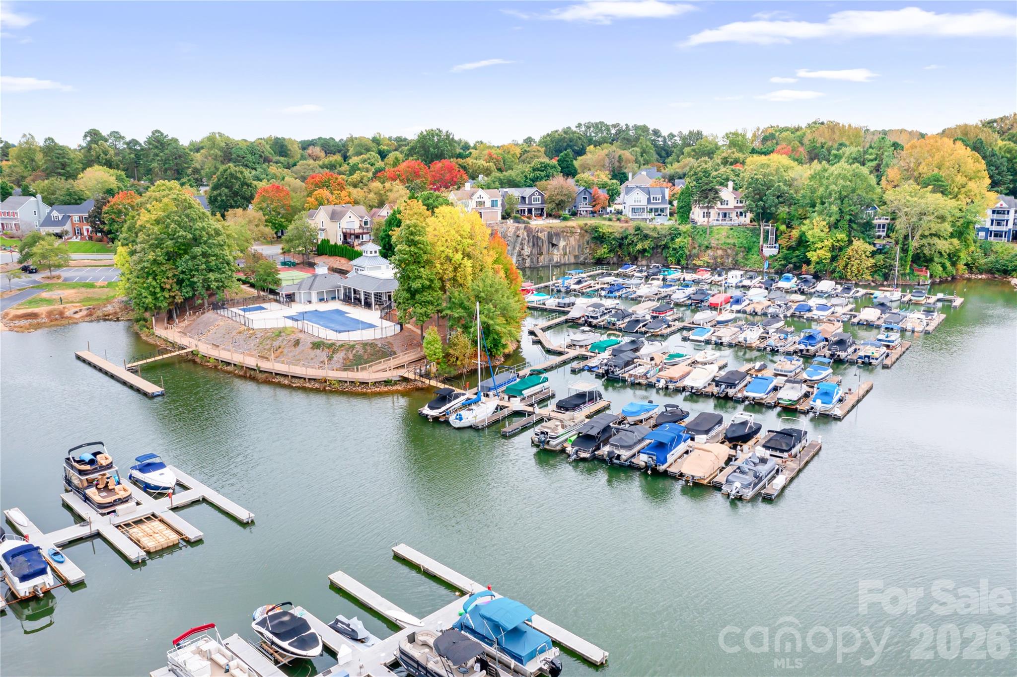 **DEEDED BOAT SLIP** #100 on Lake Norman! Updated home with New Roof, Windows, Carpet, Paint and other improvements over the last 2 years! MOVE-IN ready! Take a dip in the Hot Tub or share a drink with a friend at the outdoor bar! Kitchen features quartz counters and large breakfast bar perfect for entertaining! Soaring Ceilings in the Family room with modern fan and wood burning fireplace. Solid Flooring throughout main level and freshly cleaned carpets upstairs. Primary Suite has vaulted ceilings and walk-in closet. Come and enjoy one of the most desirable neighborhoods in the area! Live like you are on vacation! Marina, pool, Clubhouse, Dock, Boat Ramp, Tennis/Pickleball Court and more! Enjoy Summer Sunsets, Floating in the lake, or take your boat to one of the on-water restaurants on Lake Norman! There is ALWAYS something to do! Tons of Restaurants, bars, grocery stores, gas stations, banks and more right outside the neighborhood!  Take in the local Cornelius Nightlife at one of the many restaurants/bars with live music playing or see a show at the Cain Center for the Arts! Easy access to I77! Approx. 30 Min to Charlotte Airport. Come and LIVE the LAKE LIFE! Motivated Seller!
