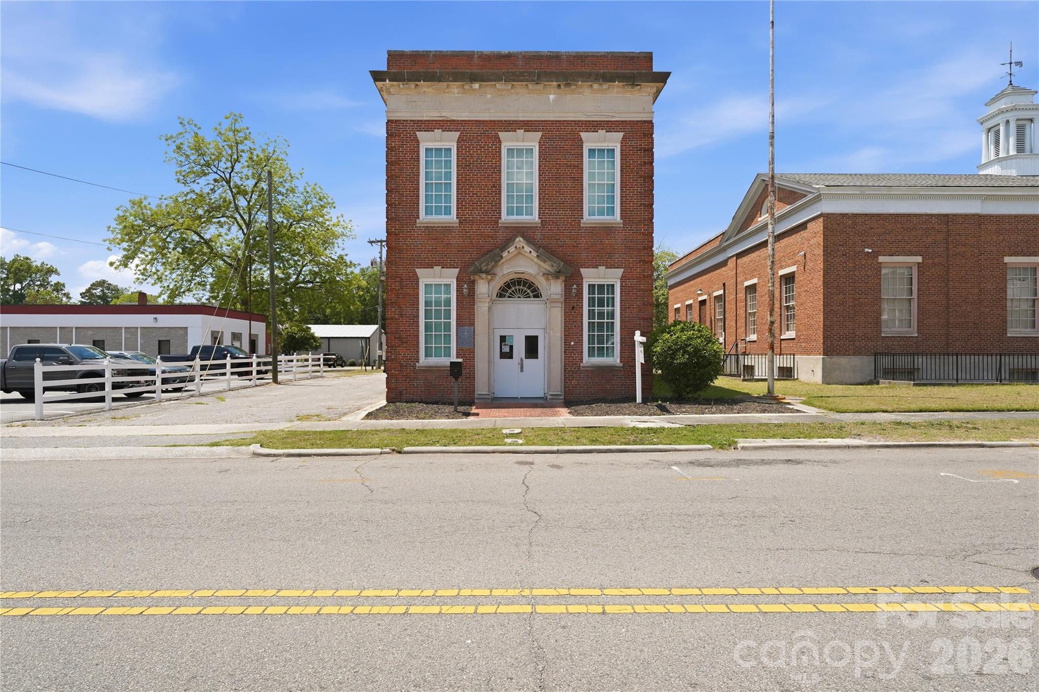 Positioned in the heart of historic downtown Laurinburg, this income-producing commercial property offers a rare opportunity to invest in a growing downtown district with strong long-term potential. Located just one block from Main Street, the historic Sanford Building combines immediate cash flow with the character and charm of Laurinburg’s early commercial architecture. Built in 1959 and encompassing approximately 5,027 square feet, the property is being sold with an existing lease in place, providing instant income for the next owner. Lease terms and tenant information are available upon request.

Known locally as the Sanford Building, the property reflects the rich history of downtown Laurinburg’s railroad-era growth and commercial development. Its classic brick exterior and prime downtown location place it among a corridor seeing continued revitalization and investment. Since becoming an official NC Main Street community in 2018, Laurinburg has experienced renewed momentum with the addition of new small businesses, community events, streetscape enhancements, façade improvements, green spaces, and infrastructure upgrades designed to support downtown growth and entrepreneurship.

Several nearby historic buildings have already undergone successful adaptive reuse into retail, office, event, and mixed-use spaces, further strengthening the appeal of the downtown district. With its proximity to Main Street and location within a city focused on preservation-based economic development, the Sanford Building presents excellent potential for future redevelopment, expansion, or repositioning as demand continues to grow. Whether you are looking to add a stable income-producing asset to your portfolio or invest in the future of downtown Laurinburg, this property offers both current returns and long-term opportunity!