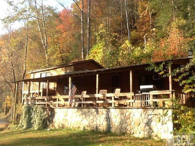 Rare opportunity to own approx. 242 feet frontage on beautiful Wilson Creek. This Unique property presently being used as Air B&B and sits on 3.52 acres with small waterfall, spring and pond. Rear of property adjoins National Forest lands. Beautiful views of the creek and surrounding area, not to mention all the outdoor activities like hiking, trout or fly fishing or kayaking right outside your front door. This three bedroom, two bath home has been remodeled in recent years and features a rustic but warm interior of mainly wood floors, walls and ceilings. Eat-in-kitchen features garden windows where you can hear the waterfall with fridge and new gas stove included. Relax on the huge front porch or have a picnic by the creek.