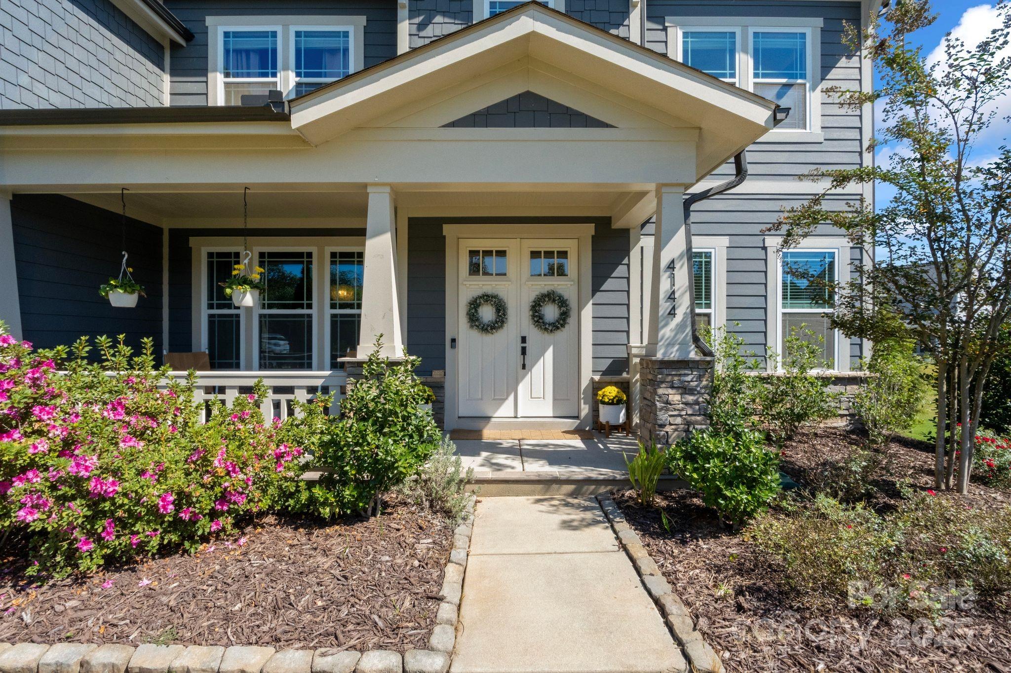 Welcome to 4144 Oarman Court, a gorgeous modern home in the highly sought-after Masons Bend community. Built in 2021, this home perfectly blends contemporary design, functionality, and comfort. With over 3,600 sq. ft. of living space on a 0.37-acre landscaped lot, it offers luxury living with a relaxed, suburban vibe.

Inside, the thoughtfully designed floor plan offers a bright, open feel. The living room features a beautiful fireplace and large windows that flood the space with natural light. The gourmet kitchen is a showstopper, boasting beautiful finishes, a custom pantry, and a generous island - ideal for entertaining or everyday living. A main-level guest suite or flexible office adds convenience and privacy.

Upstairs, the primary suite is a private retreat with a spa-like bathroom featuring dual vanities, soaking tub, glass-enclosed shower, and a walk-in closet. Additional bedrooms and full bathrooms make for easy living, while the upstairs laundry room makes household chores effortless.

Step outside to the screened-in covered porch, overlooking a spacious backyard - perfect for relaxing, entertaining, or enjoying your morning coffee. Additional highlights include a 3-car attached garage and ample driveway parking.

Residents of Masons Bend enjoy resort-style amenities, top-rated Fort Mill schools, and a prime location just minutes from shopping, dining, and Uptown Charlotte.