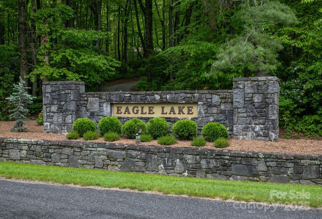 Lot 306 Old Spring Rd., Brevard. Lots in Eagle Lake are rare and this is one of the few remaining ones available in this coveted community. Ideal typography for building a second home or permanent residence, this 1.5+ acre parcel offers privacy, yet is still near the lake and amenities. This property boasts a creek and backs up to an 184-acre parcel for an added land buffer. The community features a 32-acre lake for fishing, swimming, and boating, a sandy beach, canoe storage, and a playground picnic and firepit area. Less than 15 minutes from downtown Brevard, offering shopping, dining, and entertainment. Nearby attractions include Brevard Music Center, Brevard College, and Porter Center. Access to hiking, running, biking, fishing, and horse trails in DuPont Forest and Pisgah National Forest. Completed community with paved roads and underground utilities. Perfect for creating lasting memories in a private lake community. Owner pays $3500 Impact Fee, paid before building