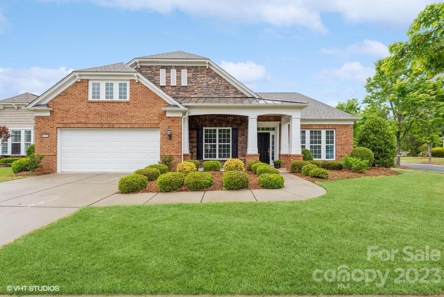 Get ready to be amazed by this beautifully designed ranch-style home that exudes timeless elegance and boasts numerous upgrades throughout. The open and airy floor plan welcomes you with high ceilings, large windows, and stunning hardwood floors. The gourmet kitchen is a chef's dream, featuring SS appliances, a spacious center island, a walk-in pantry and so much storage. The great room is perfect for entertaining, while the cozy fireplace adds charm and warmth. Relax in the sunroom with a book in the mornings, and retreat to the tranquil primary suite at night. The ensuite bath boasts an oversized double vanity, a walk-in closet, a soaking tub, and a separate shower. Other highlights include two bedrooms with their own bathrooms, a private backyard with a patio area for outdoor dining and entertaining, and an extended two-car garage with additional storage space. Don't miss this rare opportunity to own a truly exceptional property in amenity-rich Carolina Lakes!