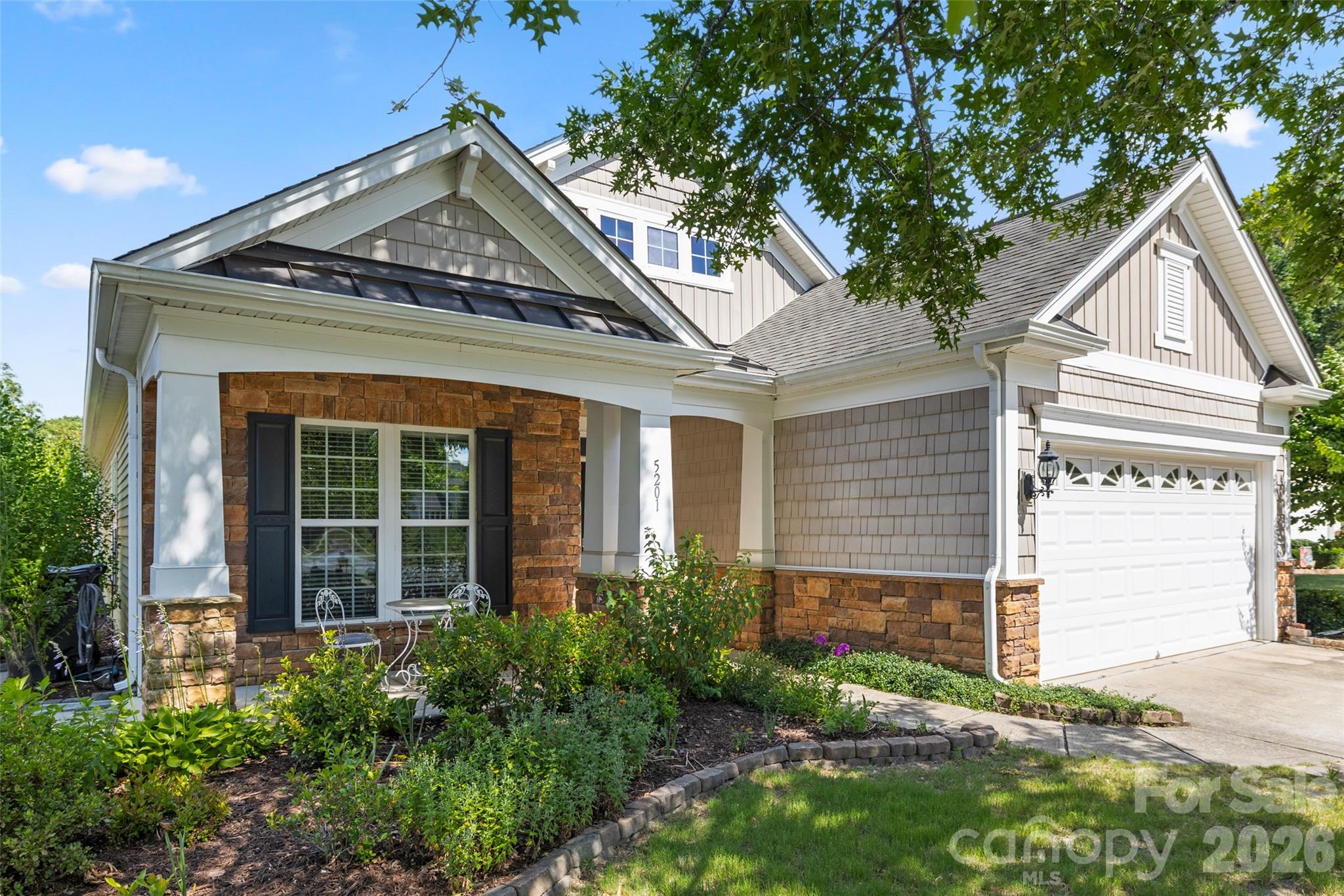 Welcome Home to Belair at Carolina Lakes! Nestled in one of Indian Land’s most highly sought-after communities, this gorgeous home perfectly balances traditional charm with an easy, modern floor plan. From the moment you arrive, the exceptional curb appeal captivates with a stunning stone-accented facade, classic vertical and shake siding, a welcoming front porch and brick-lined driveway. 

Step inside to discover a bright and airy interior filled with elegant architectural details, including pristine crown molding, tray ceilings, and timeless judge's paneling in the formal dining room. The heart of the home features a spacious, open kitchen equipped with classic white cabinetry, granite countertops, sleek stainless-steel appliances, recessed lighting, roll-outs in the lower cabinets and a wrap-around breakfast bar, perfect for casual dining and entertaining. Stove, microwave & dishwasher replaced in 2023 and new disposal in 2026.

The living areas flow seamlessly, highlighted by a cozy corner electric flame fireplace in the family room. Off the main living space, the bright home office features a striking accent wall and ample room for multiple workspaces or a quiet reading nook. Retreat to the spacious primary suite, complete with an elegant tray ceiling and an expansive en-suite bathroom boasting an oversized walk-in shower, long double-sink vanity, seating area and abundant drawer storage.  

Saving the best for last, step through the massive sliding glass doors into your private outdoor oasis. The back patio looks out onto a premium peaceful English natural garden backing directly to the serene, protected woods of Six Mile Creek. This property offers an incredibly private retreat where you can walk down the steps right down to Six Mile Creek to unwind, enjoy the mature landscaping and watch the beautiful local wildlife right from your own backyard!