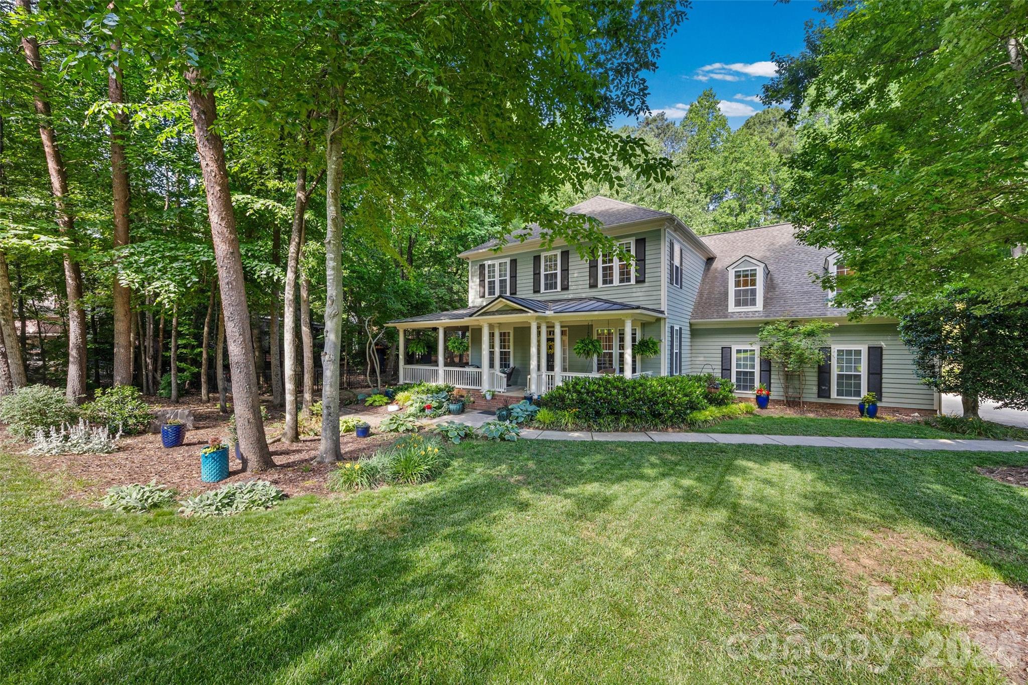 This one is a show stopper located in one of Lake Wylie's most desired neighborhoods, known as The Landing.  This two-story home sits on a private wooded lot with tons of updates.  The wrap-around front porch is wonderful for relaxing with a great book or simply enjoying your morning coffee.  The owners really enjoy having dinner on the side porch, which is adjacent to the kitchen area, especially on Spring and Fall evenings when the Carolina weather is so beautiful. On the main level, you will enjoy nice hardwood floors, a formal dining room, a home office with built-ins, a living room, a family room that is open to the kitchen, and a breakfast sitting area.  Updated kitchen with SS appliances, bar seating, walk-in pantry, and granite countertops. Upper level has a very spacious primary bedroom, with a walk-in closet, an updated bathroom with a soaking tub, and a separate shower.  There also three additional bedrooms and two additional full baths, a loft/playroom, flex space and the laundry room. Backyard is private, shaded with wonderful trees surrounding the paver patio, great for entertaining family and friends.  Nice level yard is amazing for the kids and pets to play.  Oversized three-car garage and ample driveway parking!  Come enjoy award-winning Clover schools, low SC taxes, easy commutes to Charlotte International Airport, Uptown Charlotte, and hospitals.  Hop on your golf cart and visit grocery stores, restaurants, and fitness facilities. Community pool, walking trails, and kayak access to Lake Wylie. This home will be assigned to the new Lake Wylie High School less than 6 miles away!  Showings start Sunday, 05/31/26 so schedule today.