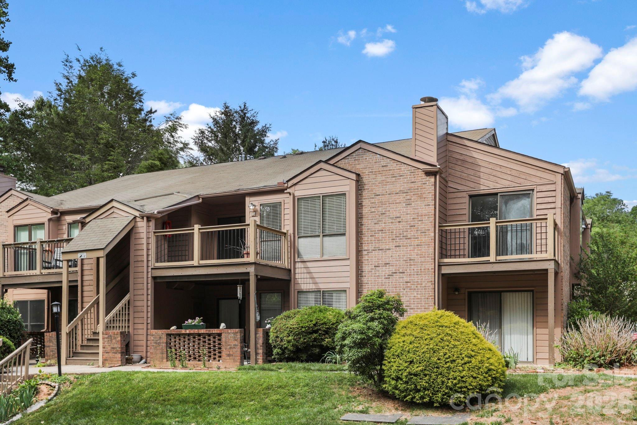 Welcome to easy living in the heart of South Asheville! This charming 2 bed, 2 bath second-level condo is tucked within an established community surrounded by mature trees. It feels private and secluded while still being conveniently close to everything in Asheville. Step inside to a functional floor plan filled with natural light. The front entry opens into the inviting living room, which features a fireplace and flows seamlessly into the kitchen and a separate breakfast/dining nook. The split-bedroom floor plan features two ensuite bedrooms positioned on opposite sides of the condo for added privacy. Enjoy being just minutes from local restaurants, shopping, and everyday conveniences, while also only 13 minutes from the Asheville Airport and less than 20 minutes to Mission Hospital, the Biltmore Estate, and the NC Arboretum. Whether you are looking for a primary residence, low-maintenance living, or an investment opportunity, this centrally located condo offers easy access to the best of Asheville living.