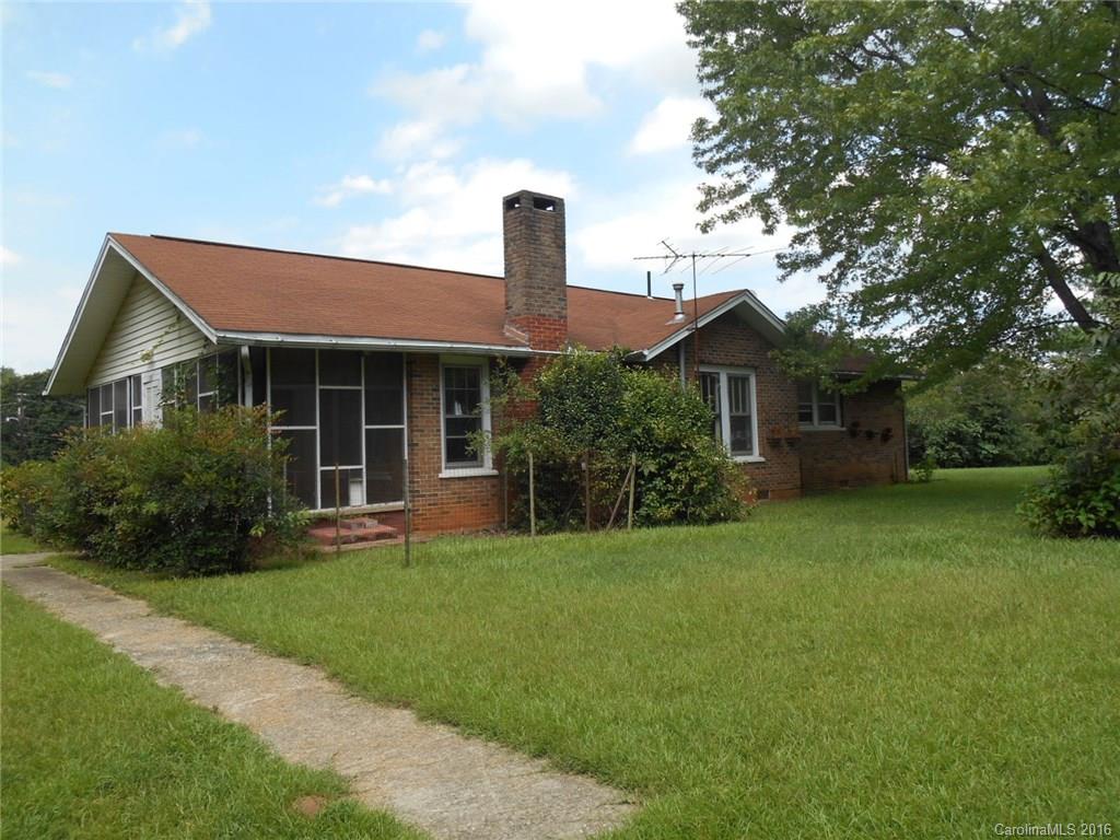 DRASTIC REDUCTION IN LANDRUM - 2.28 Acres with brick home that has been refurbished; new plumbing, sheet rock, carpet, and paint.   Nice size rooms, Fireplace in LR, large DR, and refurbished baths.  This attractive property is on a corner just outside of Landrum.  There are 2 mobiles on the property and a one car garage with workshop area.   Oh, the possibilities!  Nice property....take a look!