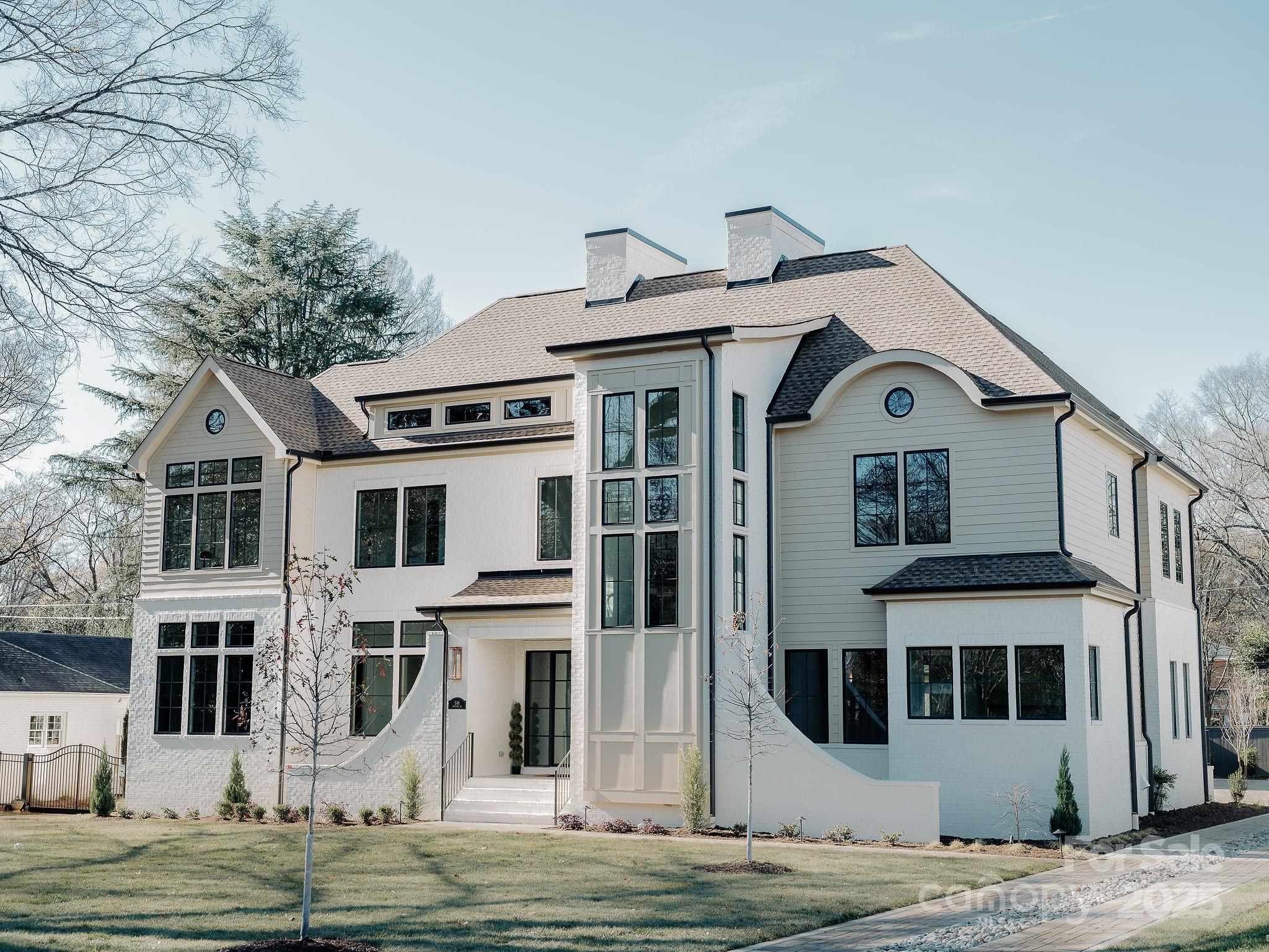The most jaw-dropping home in Lansdowne? Meet 544 Wingrave: a 5,430 sq ft, 5-bedroom, 6-bathroom stunning new construction brought to you by the esteemed team at Dapper Development. You arrive at this flagship home via a fully paved driveway of impervious pavers, accented by a striking river rock inlay that runs down the center and landscape lighting that shows off the beauty that surrounds this showstopper. The home is outfitted with a full-brick two-car detached garage...EV charger included... as well as a 16X33-foot heated saltwater pool. The interior of the home has an 11-foot primary floor ceiling along with 10-foot secondary floor ceiling and gorgeous custom wood work 22 feet high in the living room . The chef-calibre kitchen is outfitted with marble countertops and backsplash with bronze fixtures, a custom-glass-encased climate controlled wine cellar, and a whimsical tucked-away scullery. The primary suite wing is outfitted with a private office, its own laundry room, a spacious private loggia, and an oversized, beautiful bathroom with his and hers closets. All upstairs bedrooms come with fantastic walk in closets and ensuite bathrooms. Surround sound thought out the home will have you doing a two step while doing laundry in one of the three laundry rooms throughout the house or providing beautiful background music during celebrations. And an encapsulated crawls space to boot! Don't miss out on this opportunity to own a once-in-a-lifetime residence in the heart of one of Charlotte's most admired neighborhoods.