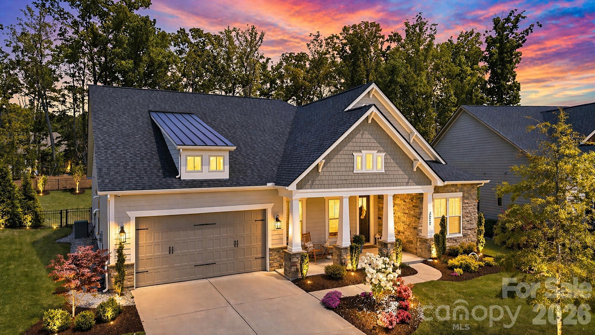 This beautifully maintained single-story home offers a refined blend of modern comfort and elevated living in a sought-after, newer community. This move-in-ready residence features 8 foot doors, 10 foot ceilings and an open-concept layout filled with abundant natural light, creating a bright and inviting atmosphere throughout. The spacious kitchen flows seamlessly into the living and dining areas, making it ideal for both everyday living and effortless entertaining. Expansive sliding glass doors extend the living space outdoors to a covered patio and a thoughtfully designed backyard. Surrounded by mature foliage, the private wooded backdrop offers a rare sense of tranquility with protected green space behind the home. A fire pit creates the perfect setting for relaxing evenings or gathering with guests. The well-proportioned bedrooms provide comfort and privacy, while the single-story design enhances convenience and livability. This home includes custom designed closets in primary bedroom and pantry. The garage features durable epoxy-coated flooring, adding both function and a clean, polished finish while the outside patio/lanai includes a polyaspartic floor coating. Residents enjoy access to exceptional community amenities including a pool, clubhouse, playground, dog park, and scenic walking trails. Ideally located just minutes from Carolina Commons, this home also offers convenient access to Ballantyne (approx. 10–15 minutes), Uptown Charlotte (approx. 25–30 minutes), and Charlotte Douglas International Airport (approx. 30–35 minutes), making it perfectly positioned for both daily living and commuting. Blending indoor comfort with outdoor tranquility, this home delivers style, privacy, and everyday ease in a prime location.