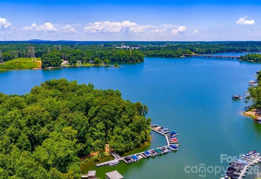 Build your dream lakefront retreat on this exceptional .62-acre waterfront homesite in the desirable Mt Isle Harbor community. Offering approximately 76 feet of shoreline on beautiful Mountain Island Lake, this property features a gently sloping, walkout basement setting with expansive water views and endless possibilities for custom design.

The sale includes a Deed of Exclusive Right to use Boat Slip #87, conveniently located just across the street from the community boat storage area. 

Bring your own builder and create the lake lifestyle you've always envisioned, with plenty of space for outdoor living, entertaining, and enjoying the peaceful surroundings. Mt Isle Harbor offers outstanding amenities, including an Olympic-sized pool, clubhouse, tennis courts, soccer field, walking trails, playground, and lake access.

Ideally located just minutes from Uptown Charlotte, Charlotte Douglas International Airport, shopping, dining, and everyday conveniences, this rare waterfront opportunity combines the tranquility of lake living with the accessibility of city amenities.