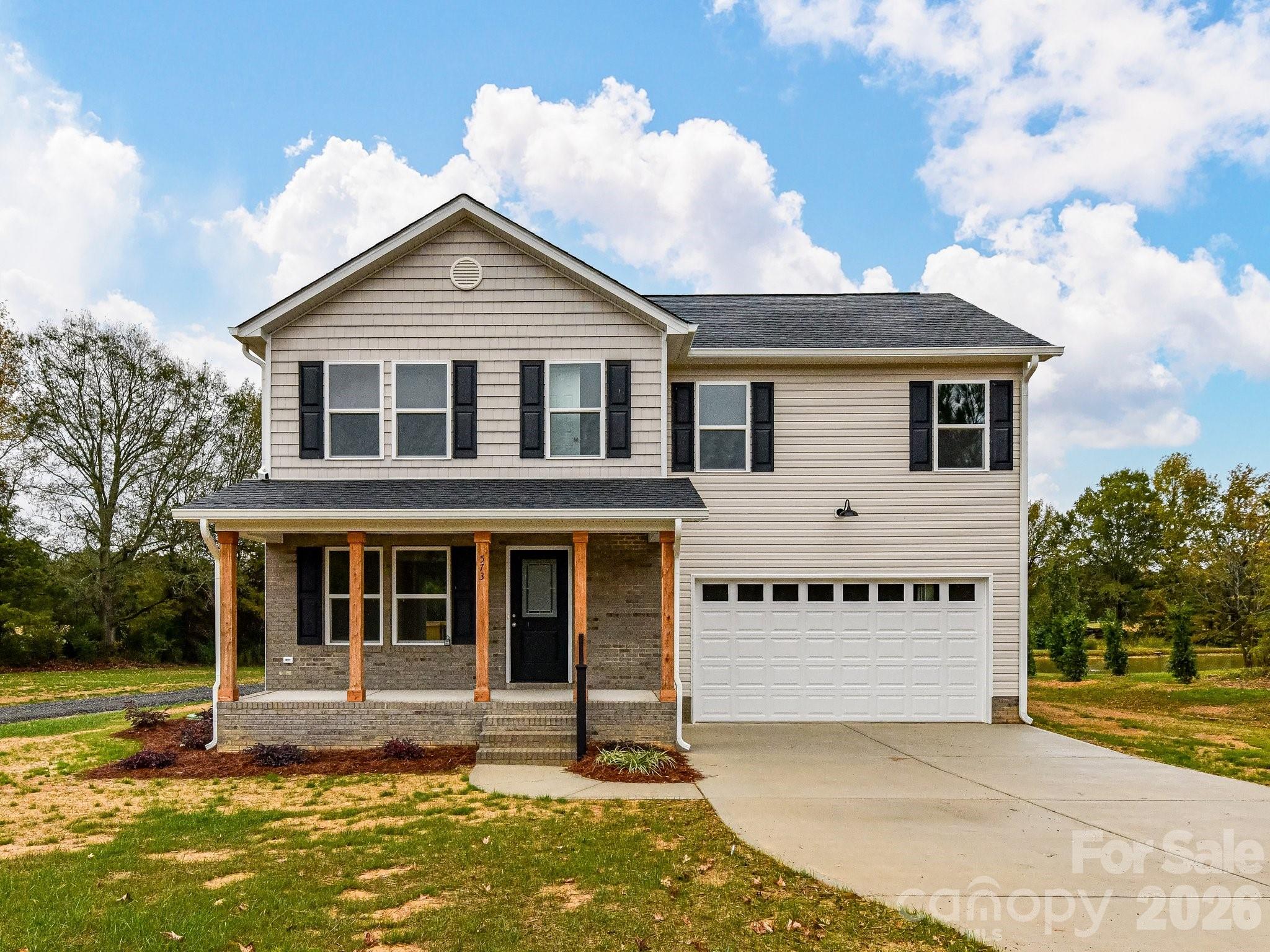 Welcome home to unmatched craftsmanship and freedom with NO HOA! This meticulous, custom-built new construction leaves absolutely no detail undone. A charming front porch with striking cedar posts and a sleek black handrail creates instant curb appeal. Inside, the open floor plan flows over gorgeous luxury vinyl plank flooring throughout the main level.The chef’s kitchen boasts custom cabinetry, quartz countertops, stainless steel appliances, and an expansive laundry room featuring a custom built-in pantry. Escape to the massive primary suite, complete with a huge walk-in closet and a spa-like bath featuring dual vanities, a soaking tub, and a separate shower. Upstairs, you will find three additional spacious bedrooms and a full bath.The builder truly always goes the extra mile for your health, featuring an encapsulated crawl space with a dehumidifier for a certified clean-air environment on all his builds. Enjoy a large two-car garage with an insulated, windowed door for optimal natural light. Out back, a sprawling deck and concrete driveway await your summer cookouts. Built to last with vinyl siding and timeless brick accents, this home is pristine and move-in ready.Located just 2 miles off 24/27, you are minutes from shopping and dining in charming downtown Oakboro. Bonus equity: The identical home next door recently appraised and sold for $415,000! Call today for a private tour.
