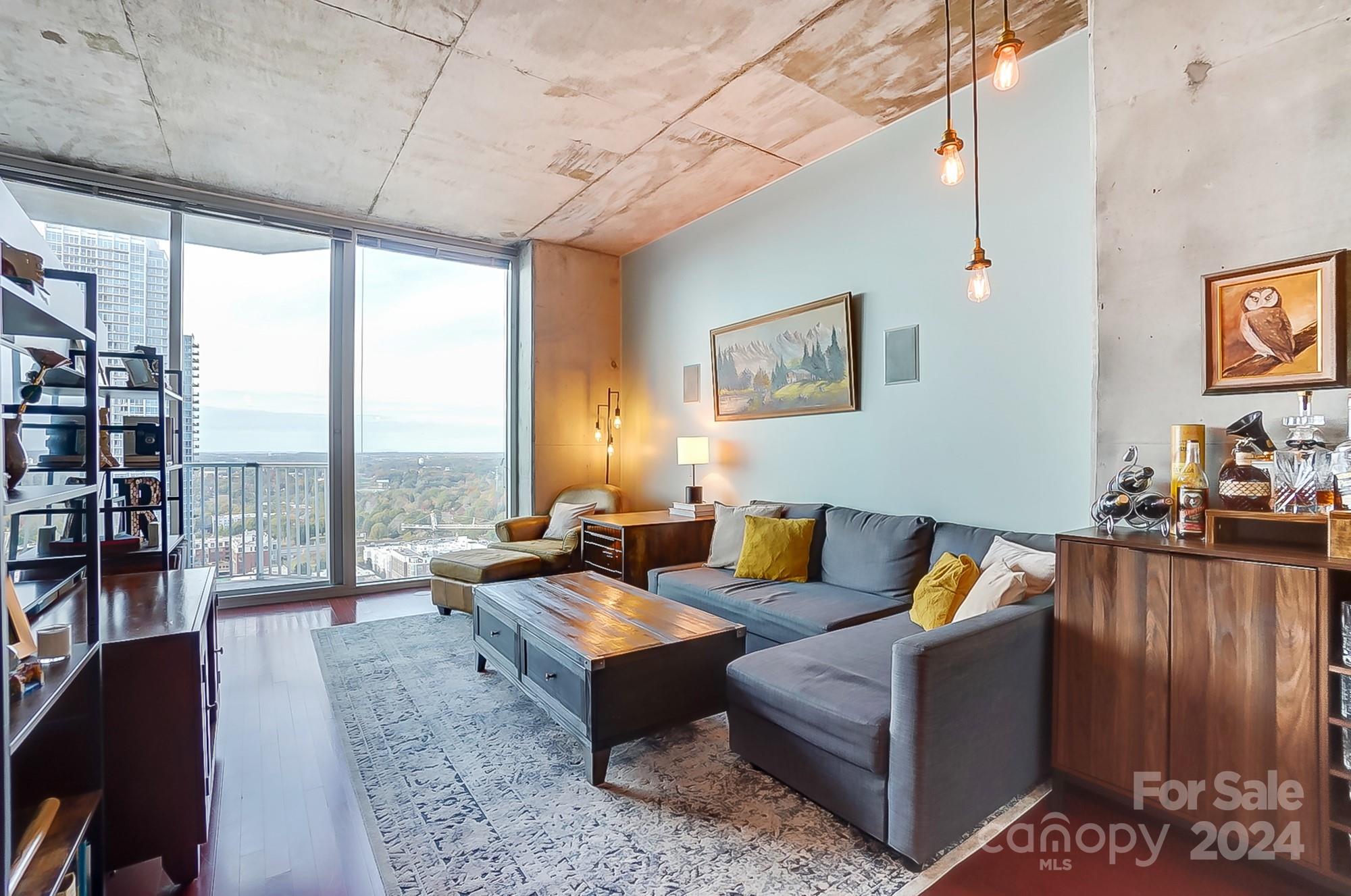 Welcome to The Avenue Condos, located in Uptown Charlotte’s vibrant Fourth Ward! This beautifully upgraded condo combines modern convenience with luxurious touches throughout, featuring custom-built closets, integrated surround sound, added in-unit storage, and fresh paint to create a sophisticated, contemporary look. Step out onto your private balcony to take in awe-inspiring views, spanning from the historic overview of Charlotte & its skyline to the distant Crowders Mountain. Designed for the ultimate lifestyle, the community offers a resort-style pool, grilling stations, and recreation spaces perfect for relaxing or hosting. Situated just minutes from Charlotte’s best dining, shopping, and cultural attractions, you’ll enjoy both the energy of the city and the serenity of your retreat. Embrace urban luxury and refined living in one of Charlotte’s most desirable locations, where elegance meets convenience at every turn. See attached for list of updates.