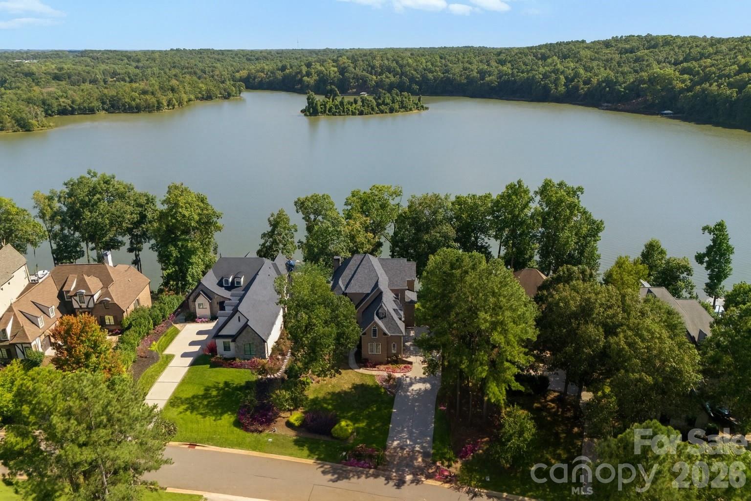 Experience refined lakefront living in this beautifully updated home within the gated community of Reflection Pointe on Lake Wylie. Thoughtfully positioned to capture expansive water views, this residence blends timeless architecture with modern updates, offering a comfortable yet elevated lifestyle defined by both design and setting.

The main level features a spacious primary suite, providing convenience and privacy, along with a recently renovated bath finished with clean lines and contemporary touches that create a spa-like retreat. The heart of the home is the light-filled living area, where large windows frame the lake and natural light pours in throughout the day. The open layout flows seamlessly to an expansive upper deck, creating an effortless connection between indoor and outdoor living—ideal for both quiet mornings overlooking the water and hosting gatherings.

The walkout lower level is designed with versatility in mind, offering a dedicated theater room, wet bar, secondary kitchen area, and multiple spaces for entertaining or relaxing. An additional flexible area provides the option for a home workout space, bonus room, or potential bedroom, allowing the home to adapt to a variety of needs. From this level, step outside to a covered patio with a saltwater hot tub, perfectly positioned to take in the lakefront setting. Newly replaced steps lead down to a floating dock with boat lift, making access to Lake Wylie simple and convenient.

A third-level bonus room adds yet another layer of flexibility, offering space that can be used for recreation, hobbies, or additional living. Throughout the property, outdoor living has been thoughtfully designed to take full advantage of the setting, with multiple areas including the upper deck, lower patio, fire pit area, and private dock—all offering unique vantage points of the water.

Additional features include a three-car garage and a small unfinished portion of the basement that provides valuable storage space. An Invisible Fence system is also in place.

Reflection Pointe is known for its well-maintained setting and strong sense of community, offering amenities such as walking trails, clubhouse, tennis courts, swimming pool, community marina, beach area, and waterfront pavilion. The location provides convenient access to nearby shopping, dining, and major highways, while still offering a sense of privacy and retreat.

This property presents an opportunity to enjoy a thoughtfully updated home in a premier lakefront setting, where everyday living is enhanced by both comfort and natural beauty. 

Schedule your private showing to experience all that this home and community have to offer.