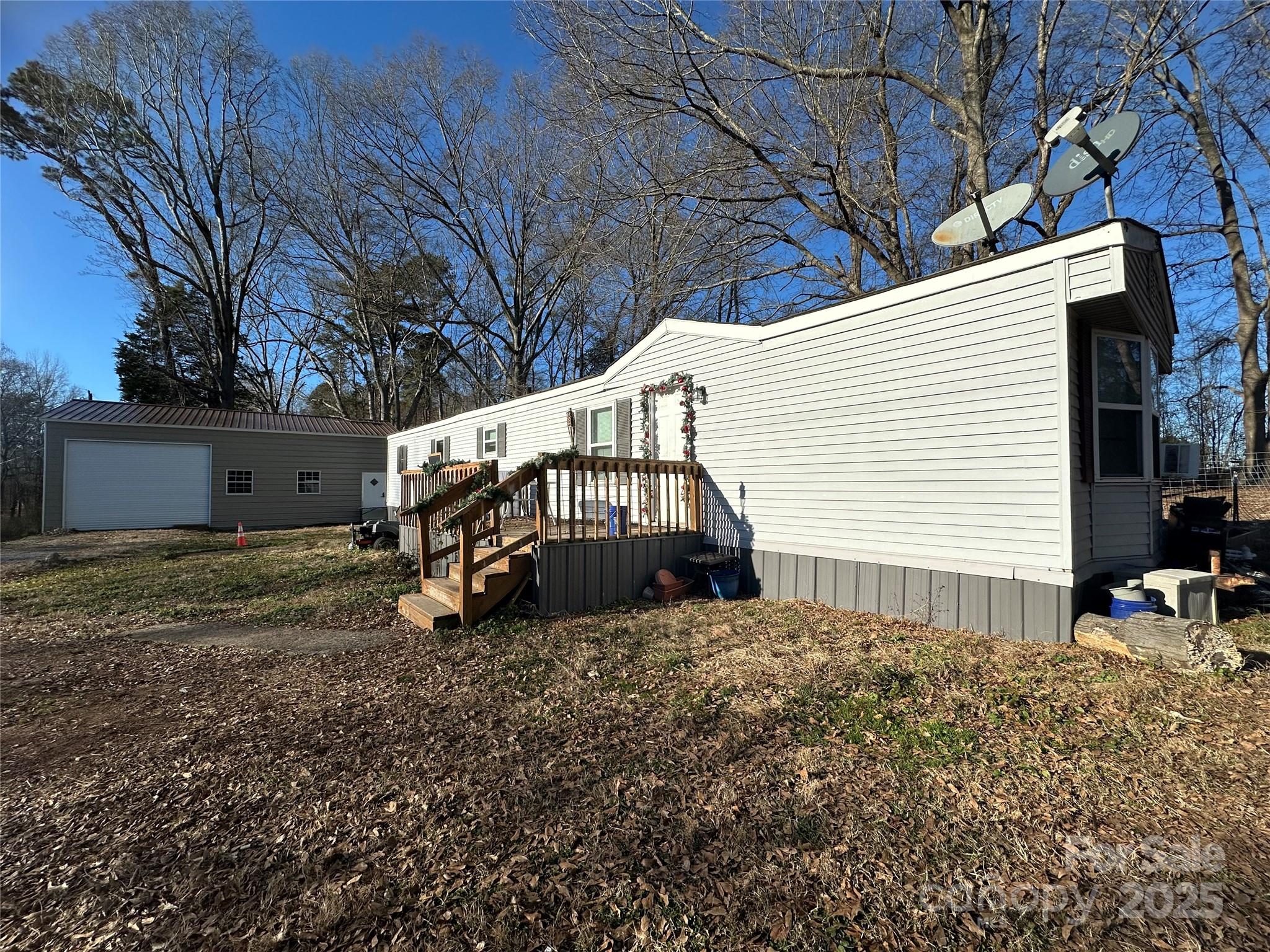 Single wide 2 bedroom, 2 bathroom mobile home on nearly one acre lot on the corner of Woodridge Drive and Lawrence Road. Great location! Large front and rear porches. New well pump in 2024. Needs cosmetic work. If you are looking for perfect, this isn't it. Large (25 x 36) metal building with 12 foot walls on property. Low county taxes. Minutes to downtown Clover and York. Priced aggressively. No lease to own. No owner financing. Cash buyers only.