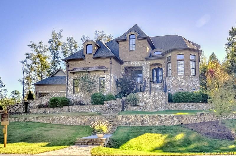 STUNNING Carefully Crafted Custom Home nestled in Gated Neighborhood moments to Ballantyne!  Private tiered lawns with expansive Patio & Covered Veranda.  Elegant open Great Room with gorgeous stonework. Sunroom with French doors (play room) adjoins true Chef’s Kitchen with spacious casual dining.  Expansive Master Suite on main. Fabulous Media Room PLUS open recreation/loft. 4 car garages!