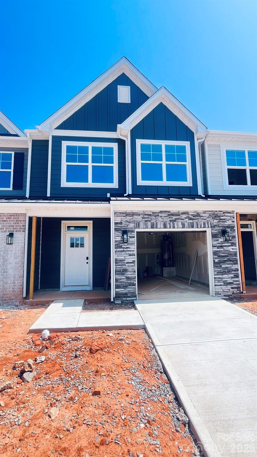 New townhomes in the heart of Waxhaw! This Ashland plan has 3 bedrooms, 2.5 baths, and more than 1,800 square feet of living space. Enter the home through the foyer with tray ceiling and Craftsman-style trim to see the open kitchen, dining area and family room that walks out to a covered porch. The kitchen features gray, Shaker-style cabinets and white quartz counters, a spacious island, tile backsplash, and stainless appliances, including a gas range. The open main floor has beautiful and durable Enhanced Vinyl Plank flooring throughout. The upper floor has the loft, bedrooms, two full baths and laundry room. The primary bath has a tiled shower with semi-frameless door and bench seat, dual-sink vanity, and linen closet. The upstairs full bath has a tub/shower combo. All baths feature gray cabinetry and white quartz counters. Walking distance to shops, eateries, and other conveniences. Visit today!