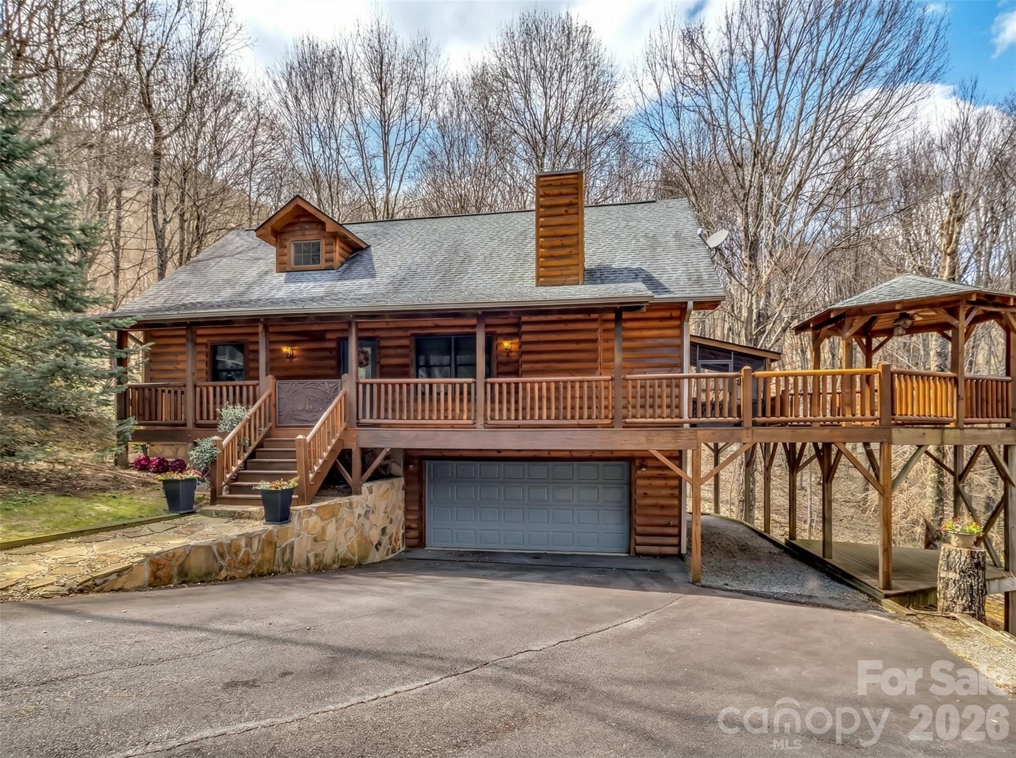 Private Mountain Log home on almost 2 acres  located in award winning  Smoky Mountain Retreat a  luxury log home community. Expansive corner lot with small creek and with views .Wrap around decks with year round views.  Screened in deck section with long range views.   Gazebo with expansive views. Turn key fully furnished including out door furniture, Anderson windows, quartz counter top in kitchen, bamboo flooring.  Upper level off Master has small sitting area with views. Master has small balcony facing the private lot.

Expansive basement could be made into a gym, office or workshop. Seller just never finished it. Extra carpet in garage.

Enjoy cooler temps at 4000 elevation with privacy. Located near hiking trail entrance. Hiking trails with multiple  waterfalls  Great open floor plan with views and deck access.  Sold furnished with a few exceptions for personal items. Home can be a full time job residence or part time. summer home.   Winter roads are plowed. Short Term Rentals are allowed thru community management. Barn can be used for private events.

 Gated SMR offers hiking trails to water falls and 200 acres. in conservation . Paved roads for year round living. 100 year old barn located near stream for community events, gazebo near stream.  playground with parking. Skyrunner internet and Spectrum. Ten minutes to Laurel Ridge Country Club using Eagles Nest gate.   Main entrance Gaddis Branch to Maggie Valley.