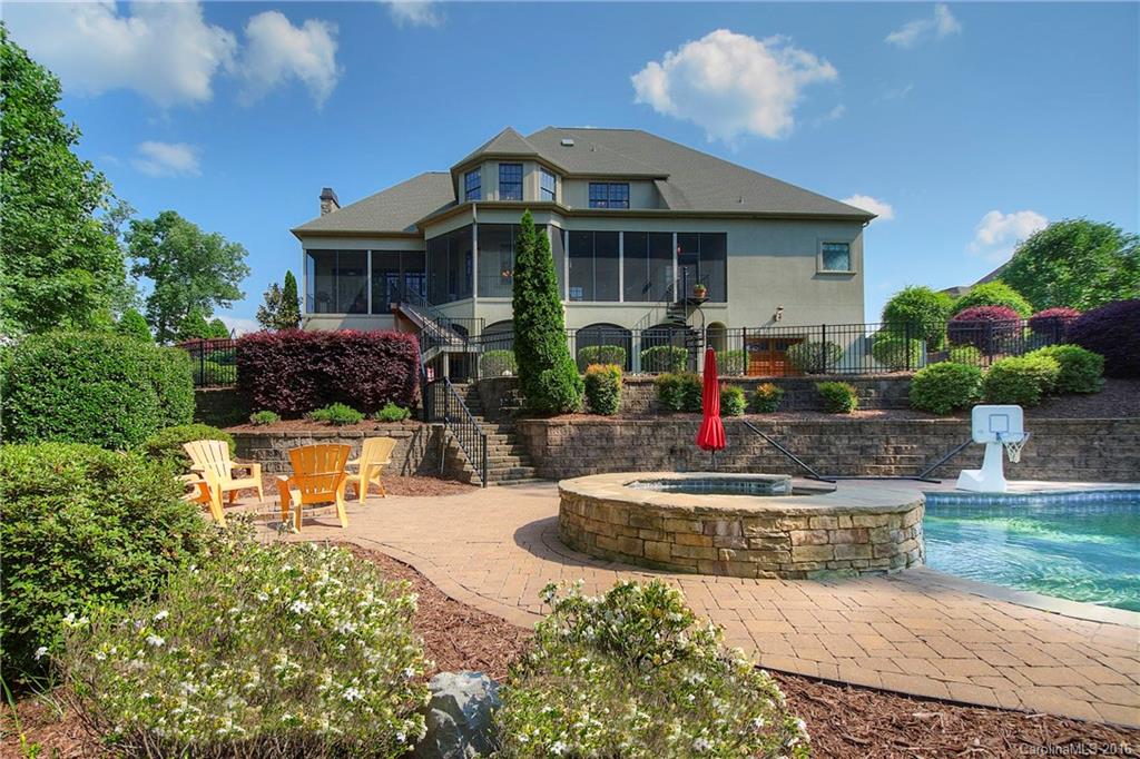 Paradise on Lake Wylie, 4 bedr waterfront! Swimming pool w/ waterfall, TWO hot tubs, outdoor living area, cvrd dock w/ boat lift and PWC lifts. Fine custom home w/ exquisite architectural details throughout: arched doorways, coffered ceilings, a graceful winding staircase. Main level master suite plus executive office. 2nd kitchen on lower level ideal for guests or extended family. Designed for entertaining: multiple screened porches, patio w/ built-in grill, game room, billiards, home theater.
