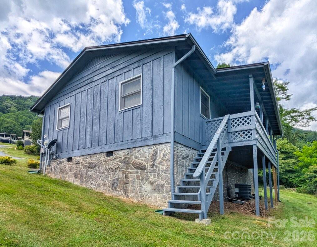 GREAT DEAL AS-IS HOME! Nestled in the well-maintained Stoney Ridge community, this one-level ranch cabin offers breathtaking mountain views and a low-maintenance lifestyle. Inside, you’ll find a spacious open floor plan, vaulted ceilings, a cozy fireplace, and abundant natural light. The covered front porch is perfect for relaxing, with a carport providing sheltered parking and easy access.

Enjoy peaceful mornings with long-range views, plus quick access to Maggie Valley’s shops, dining, and festivals, and a scenic drive to Cherokee for even more outdoor recreation.

HOA includes community road maintenance and common area upkeep. The town handles salting and plowing, while the HOA is responsible for road maintenance.

Short-term rentals are allowed after two years of ownership—see CCRs for details.

Whether you’re looking for a full-time home, seasonal escape, or investment opportunity, this property delivers the perfect blend of comfort, views, and convenience.