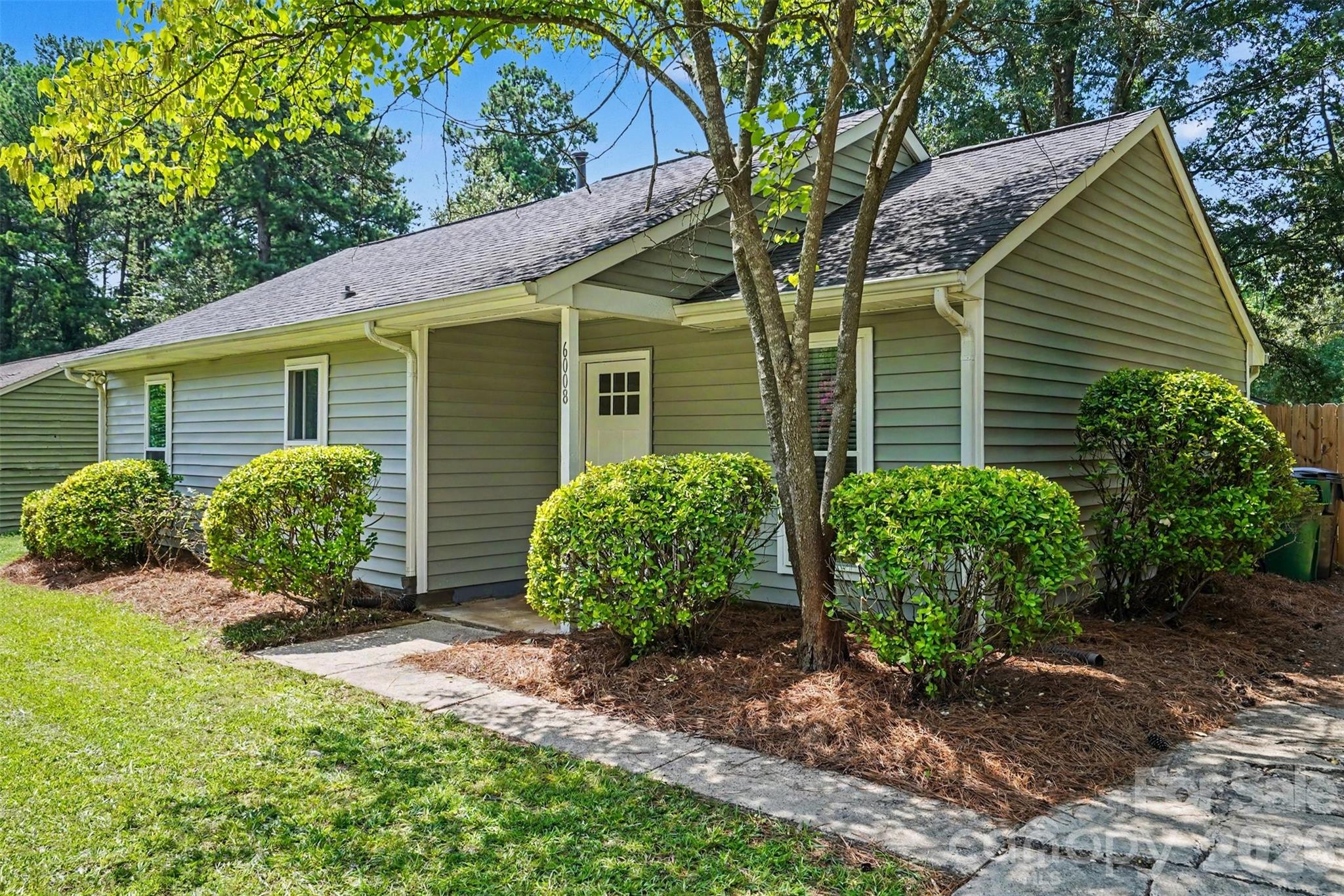 Welcome to 6008 Trysting Road, a charming ranch home in Charlotte’s established Hickory Ridge neighborhood. Inside, vaulted ceilings and abundant natural light create an open, airy atmosphere throughout the main living space. The thoughtfully designed floor plan connects the living room, dining area, and kitchen, providing an ideal layout for both everyday living and entertaining. The sliding glass door enhances the home's bright and welcoming feel, while the kitchen offers easy access to the dining area and outdoor living spaces. Two comfortable bedrooms provide peaceful retreats, complemented by a full bath and a convenient half bath. The dedicated laundry area and attic storage add practical functionality to the home. Outside, a spacious deck overlooks the fully fenced backyard, offering plenty of room for outdoor gatherings, gardening, pets, or play. Situated on a generous .30-acre lot with a storage building. This convenient location places you just minutes from Independence Boulevard, making travel to Uptown Charlotte, Matthews, Mint Hill, and Charlotte Douglas International Airport easily accessible. Residents enjoy close proximity to a variety of shopping, dining, and entertainment options.