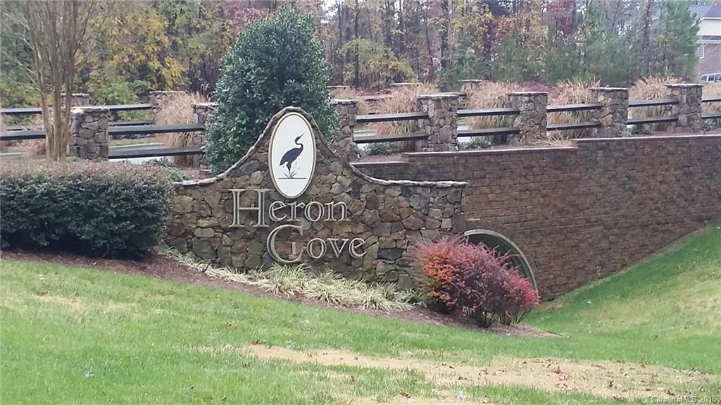 Great rectangle lot in beautiful Heron Cove in Lake Wylie. The lot will have trees in the back and at least 99ft across the front. It's located a very short distance to the Lake Park where there is a fire pit, canoe launch and more. The swimming pool is open during the spring and summer months. Former contractor said home could be built with a walk-out basement or a tall crawl space.