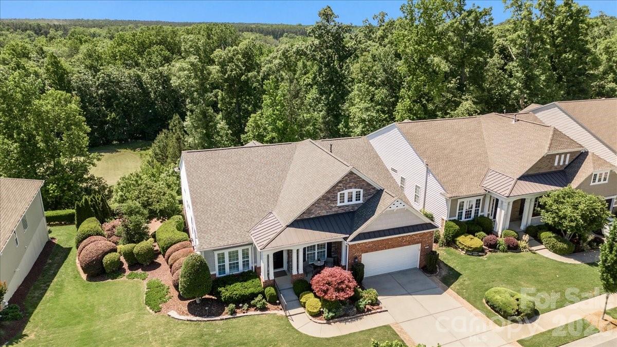 Experience the pinnacle of active adult living in this well-maintained home nestled on a quiet double cul-de-sac street in the premier 55+ community of Sun City Carolina Lakes. Positioned above the 13th fairway, this rare property captures views of the golf course and seasonal views of the Catawba River. Beautiful mature landscaping frames the home’s curb appeal, complemented by an expanded driveway, artisan slate raised garden beds, and an inviting front porch.
Enjoy ultimate peace of mind in this freshly painted, move-in-ready home packed with high-value, worry-free updates. Structural and mechanical improvements include a brand-new roof (April 2026), new guest room carpeting, and newer high-efficiency HVAC and AC systems. Prioritizing health and wellness, the property is equipped with a whole-house water filtration system and a state-of-the-art indoor air quality environment featuring an April Aire industrial dehumidifier, active air scrubbers, and MERV central filtration on both HVAC units.
As you enter the front door, this bright and inviting home welcomes you with neutral tile floors through the main living areas and private primary suite. Custom plantation shutters and wood blinds adorn the expansive windows throughout, offering effortless light control and a timeless elegance.  At the heart of the home, the gourmet kitchen is a chef's delight, featuring an abundance of cabinetry, generous counter space, under-cabinet lighting, and a spacious walk-in pantry. Arched entryways lead from the great room into a serene sunroom, where oversized windows frame colorful evening sunsets. The highly desirable split floor plan ensures ultimate guest privacy, separating the primary suite from the secondary bedrooms, which each enjoy access to a dedicated bathroom.
Designed for those who love to host, the finished walk-out basement serves as a second level of living space. This versatile haven offers ample room for everything from high-energy band practice and workouts to quiet afternoons dedicated to crafts or a competitive game of billiards. A wet bar and a dedicated wine storage room provide the perfect backdrop for unforgettable gatherings with friends and family.
The entertainment flows effortlessly from the lower level sunroom to the outside grilling area with an al fresco dining patio perfect for hosting sunset dinners. From there, a stone path leads you to a serene custom built-in water feature complete with an area for seating. Enveloped by the soothing sound of cascading water and the sweet scent of jasmine and gardenia, this space offers a tranquil retreat. It is the perfect, peaceful setting to read a book, enjoy your morning coffee, or unwind with a glass of wine. Professional landscape lighting beautifully illuminates the entire home and gardens, extending your resort-style enjoyment well into the evening hours.
Embrace the ultimate resort-style lifestyle. As a resident of this vibrant Del Webb community, you will enjoy world-class amenities just a short golf-cart ride away. Take advantage of two multi-million dollar clubhouses, indoor and outdoor swimming pools, tennis, bocce and pickleball courts, softball field, fitness center, wood shop, miles of scenic walking trails, an 18-hole public golf course woven right through and much more!