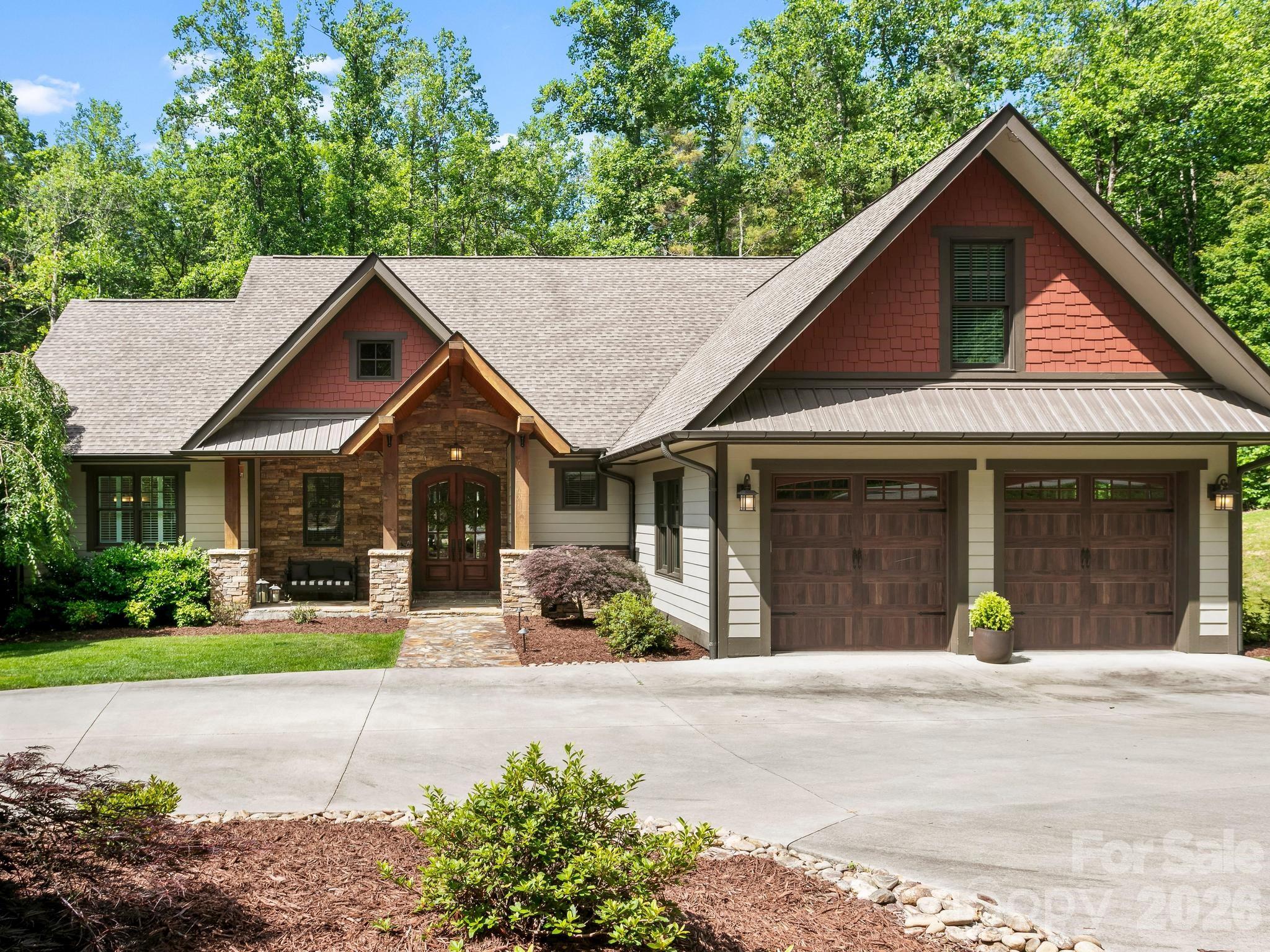 Welcome to 80 Highlander Falls Way, where mountain living meets timeless elegance. Nestled on a 2.16 acre homesite created from two combined lots, this exceptional retreat offers the privacy, beauty, and tranquility that so many dream of but few ever find.  Surrounded by nature and accented by a peaceful creek along the rear property line, this stunning home invites you to slow down, breathe deeply, and enjoy the beauty of Western North Carolina. Inside, you’ll find a thoughtfully designed floor plan featuring 3 bedrooms, 3.5 baths, and a spacious finished bonus room above the garage, perfect for a home office, recreation space, or flex room.  Whether you’re gathered around the fireplace on a cool mountain evening, enjoying coffee on the porch as the sounds of the creek drift through the trees, or entertaining family and friends in the beautifully appointed living spaces, every corner of this home was designed to create lasting memories.  Conveniently located in Zirconia, yet just minutes from the charm of Flat Rock, the amenities of Hendersonville, and the vibrant dining and shopping scene of Greenville, SC, this property offers the perfect balance of seclusion and accessibility.  Whether you’re searching for a full-time residence, a luxury mountain retreat, or a place where generations can gather and make memories, 80 Highlander Falls Way is more than a home, it’s a destination, a sanctuary, and a lifestyle all its own.  Come experience the mountain escape you’ve been dreaming of.