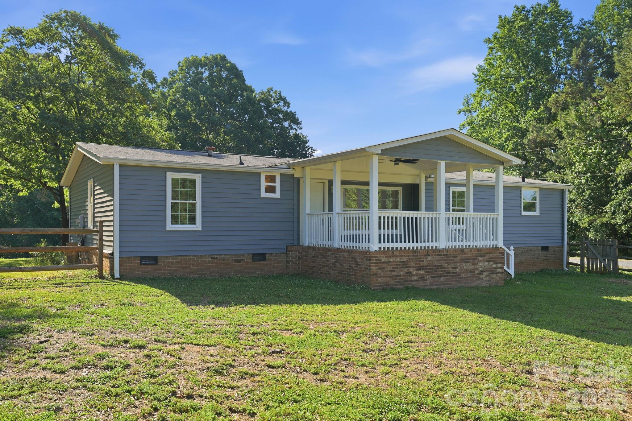 Beautifully updated home on over 1.5 acres with no HOA fees in highly desirable Indian Land. This home offers a peaceful setting with lots of space, privacy, and everyday convenience. The bright open-concept floor plan features spacious living areas, updated flooring, recessed lighting, and a modern kitchen with stainless steel appliances and ample cabinet storage. The primary suite offers a comfortable private retreat, while additional bedrooms provides flexibility for guests, office use, or everyday living. Enjoy the large yard, covered front porch, and a rear deck—perfect for relaxing, entertaining, gardening, or play. Conveniently located near RedStone, Costco, Target, Walmart, Ballantyne Bowl and award winning restaurants, Walter Elisha park, I-485 and 77.