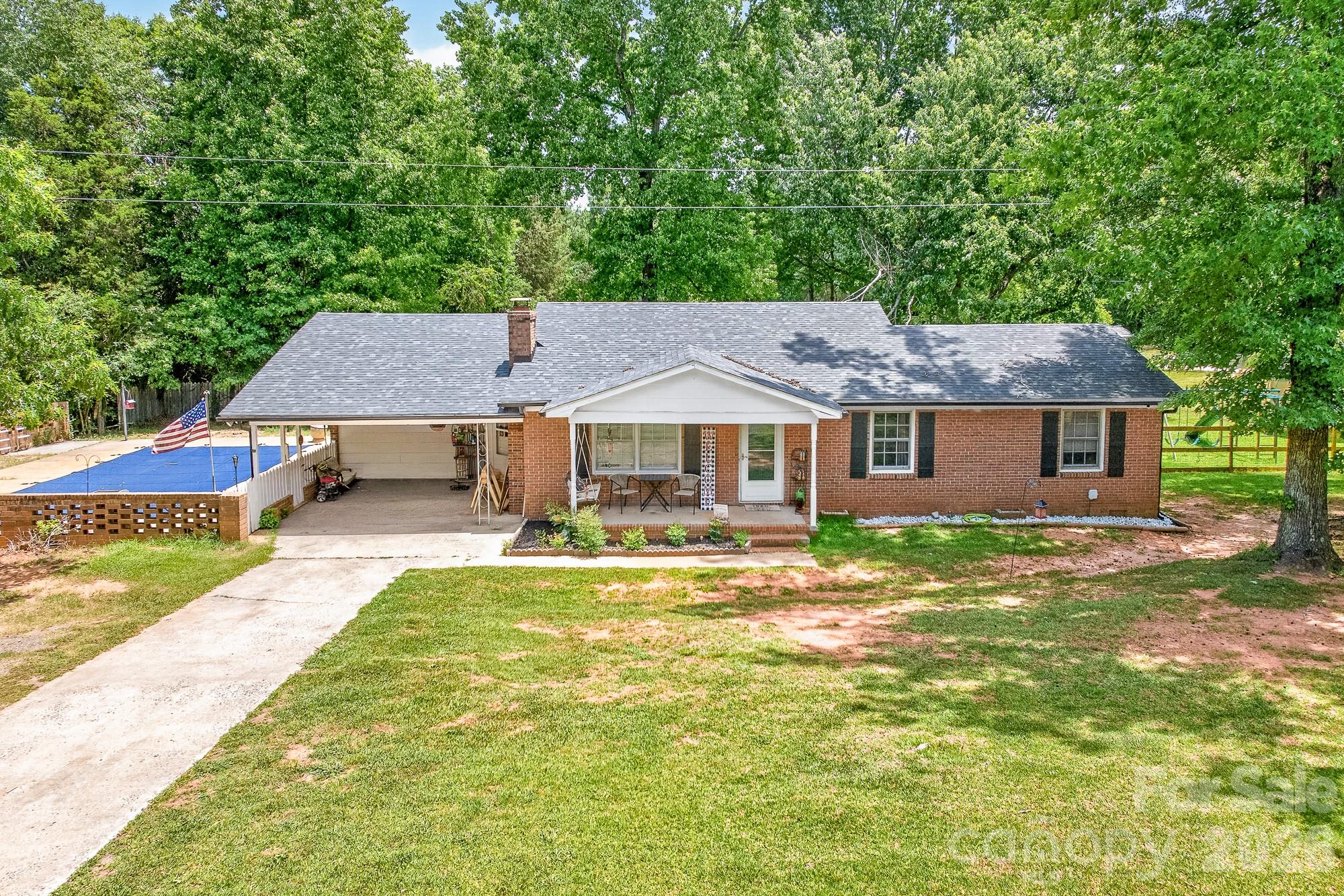 Welcome to your private retreat on 3.91 beautiful acres in York, SC! This well-maintained brick home offers approximately 1,960 square feet of living space and endless possibilities both inside and out. Recent improvements include a brand-new roof, new gutter system, and an HVAC system that is only 2 years old.

Enjoy outdoor living with a gorgeous in-ground pool surrounded by attractive brick fencing. The pool pump is in excellent working condition; the pool will need a new liner. The property also features a fenced dog play area, providing a safe space for pets to roam and play.

Inside, you'll find a spacious living room perfect for entertaining and gathering with family and friends. One bathroom has been completely renovated and updated. The primary bathroom is currently being renovated, and the estimated completion date will be updated once available. Upon completion, the finished primary bathroom square footage will be added to the MLS, and the total heated living area will be adjusted accordingly.

Need space for projects, hobbies, or equipment? The property includes two additional buildings, offering the perfect opportunity to create the workshop of your dreams, store recreational vehicles, or establish a home-based business. Enjoy the privacy of country living while remaining conveniently located near York and surrounding amenities.