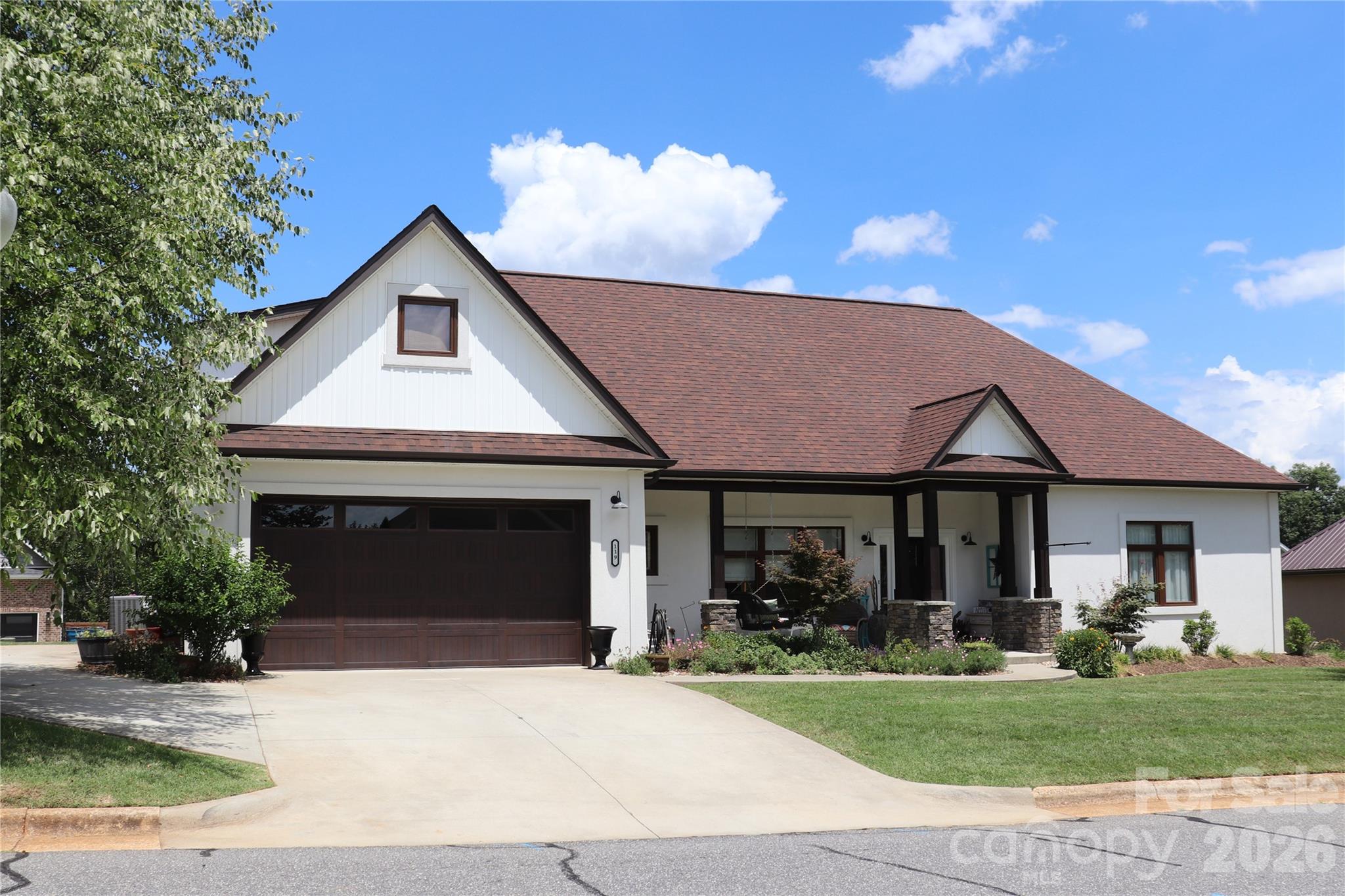 Stunning 4-bedroom, 3-bath, one-and-a-half-story home featuring an open-concept design in Granite Falls with convenient access to Hwy 321. Built for exceptional energy efficiency, this home showcases ICF (Insulated Concrete Form) exterior walls and European insulated windows. The main level offers 10-foot ceilings and an impressive 18-foot vaulted ceiling in the living room and kitchen, highlighted by a faux wood beam and a floor-to-ceiling stone accent with an electric fireplace. Additional features include a dual-zone HVAC system with separate thermostats for enhanced comfort and efficiency. Luxury laminate flooring flows throughout the main living areas and bedrooms, while the laundry room and bathrooms feature stylish tile flooring and beautifully tiled showers. The primary ensuite includes a bath with quartz-countertop dual vanity, a soaking tub, and a separate shower. Two additional bedrooms, a full bath, and the laundry room are also conveniently located on the main level. The kitchen is appointed with quartz countertop and tile backsplash, providing both elegance and functionality. Upstairs, you'll find a versatile bonus room, a fourth bedroom, and a full bath—ideal for guests, a home office, or additional living space. Situated on a beautifully landscaped lot, the property offers front and rear driveways, a front-facing two-car garage, a welcoming covered front porch, and a relaxing covered rear patio. An open space owned by the Town of Granite Falls borders the left side of the property, enhancing a sense of openness. Don't miss the opportunity to own this well-maintained, one-owner home—schedule your private showing today!